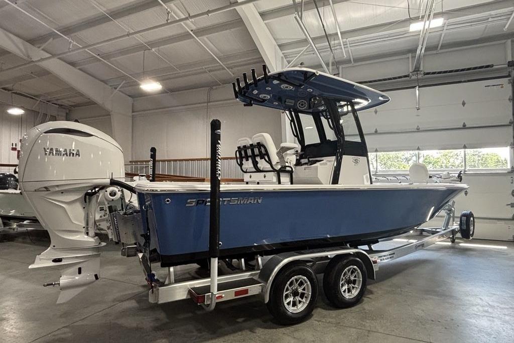 2026 Sportsman Masters 247 Bay Boat with Yamaha engine in a garage setting.
