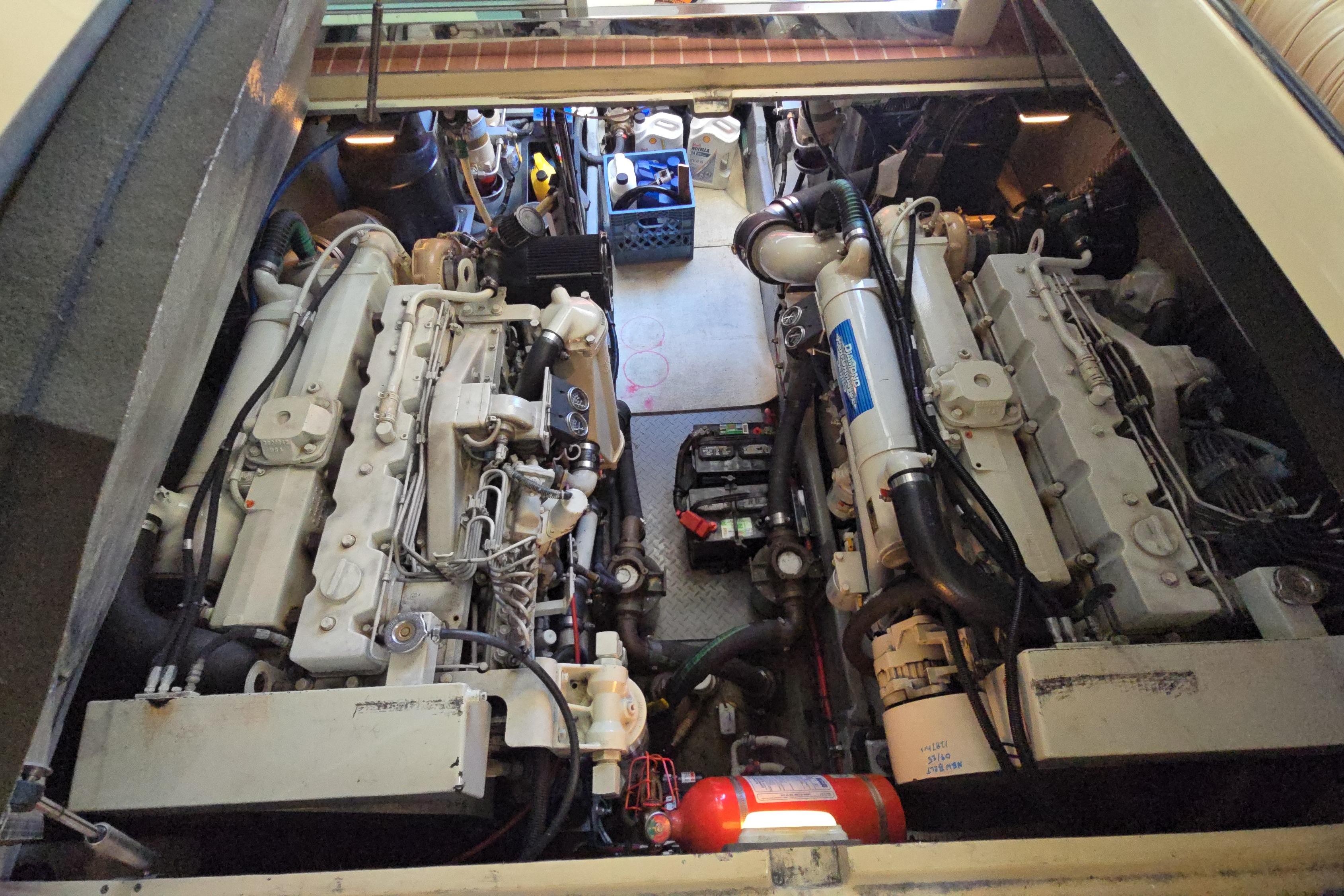 Engine room of a 2001 Sea Ray 400 Sedan Bridge, showcasing dual engines and equipment.