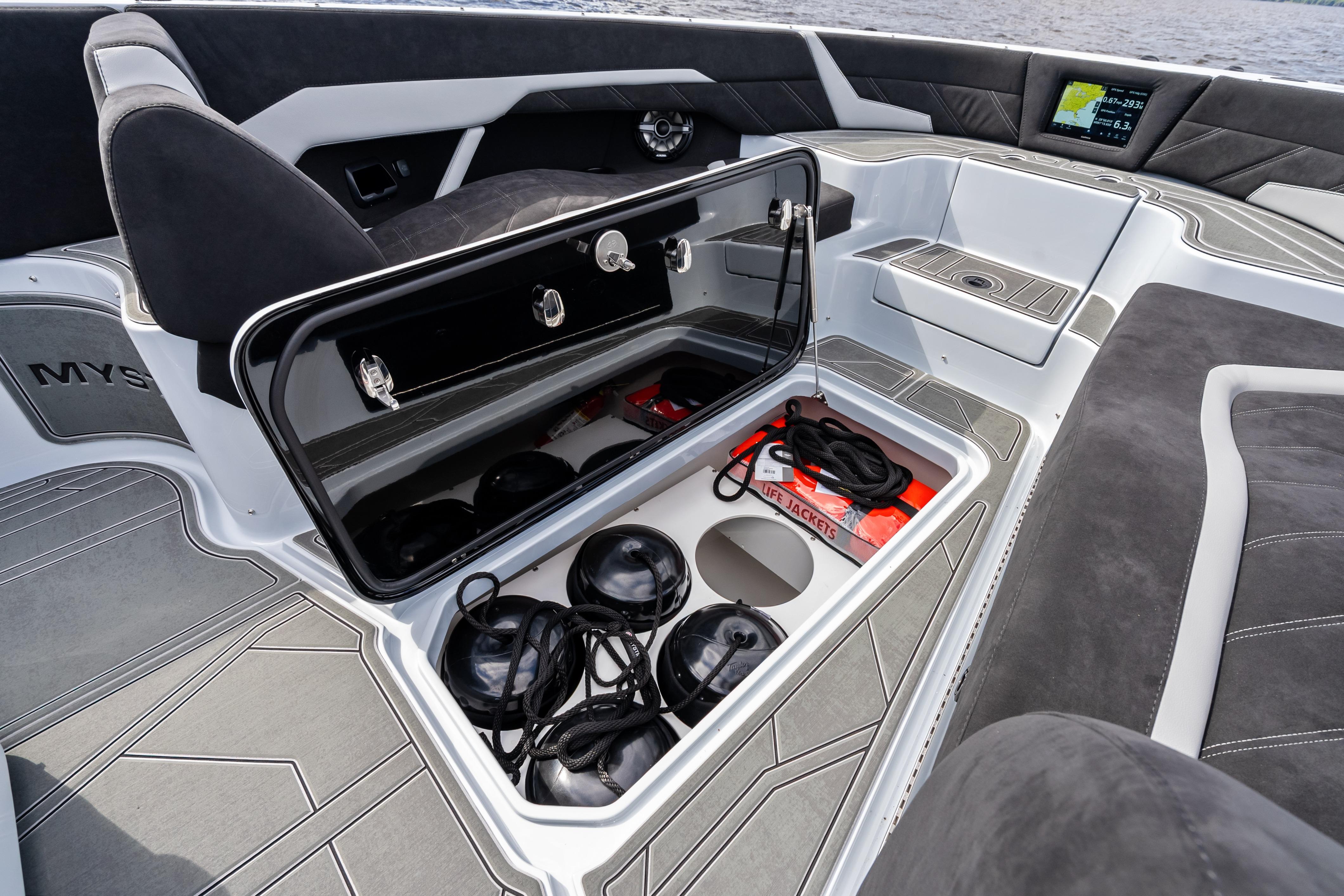 2027 Mystic Powerboats M4200 interior storage with life jackets and ropes on deck.