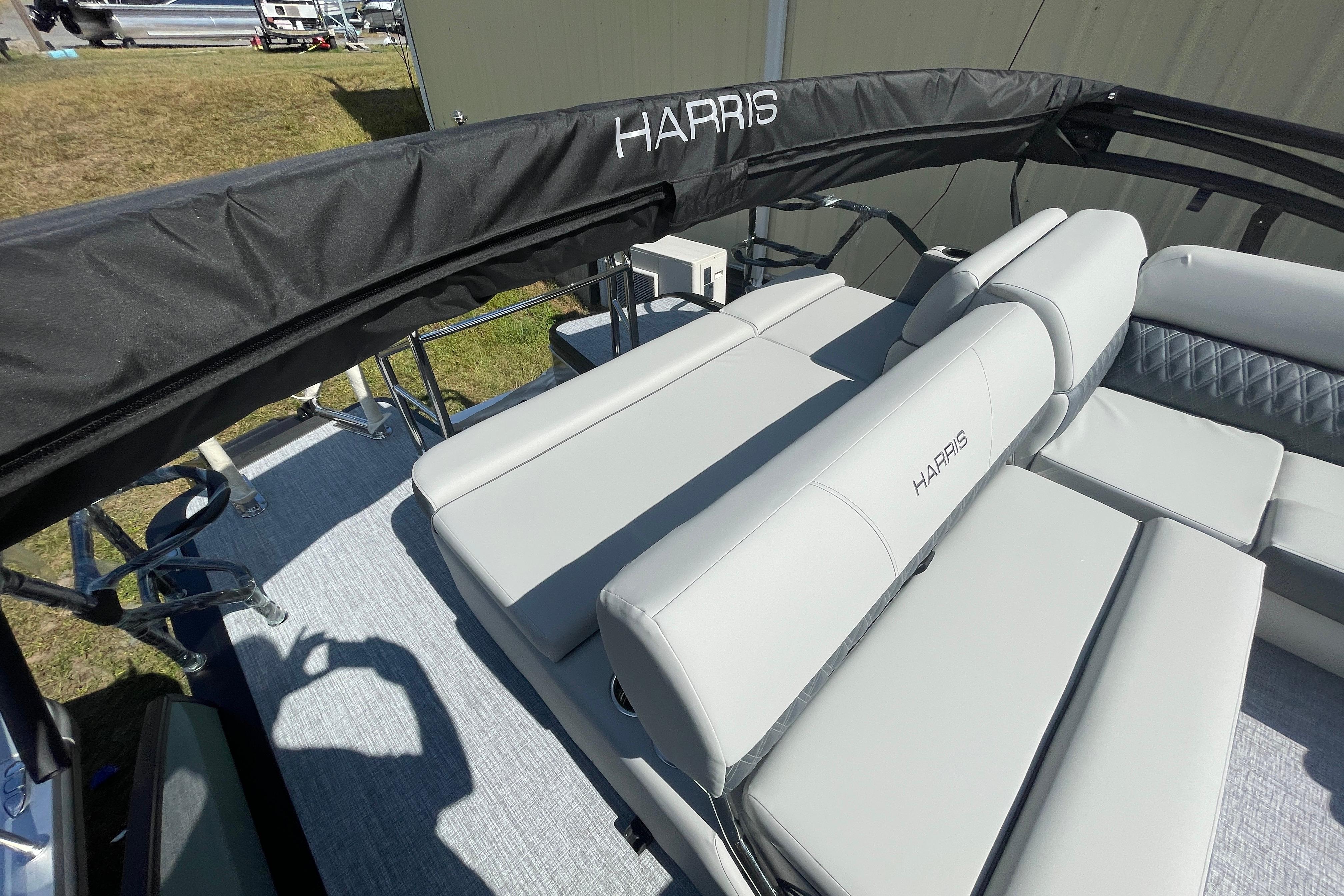 2026 Harris Cruiser 210 SL boat interior with sleek seating and branded cover.