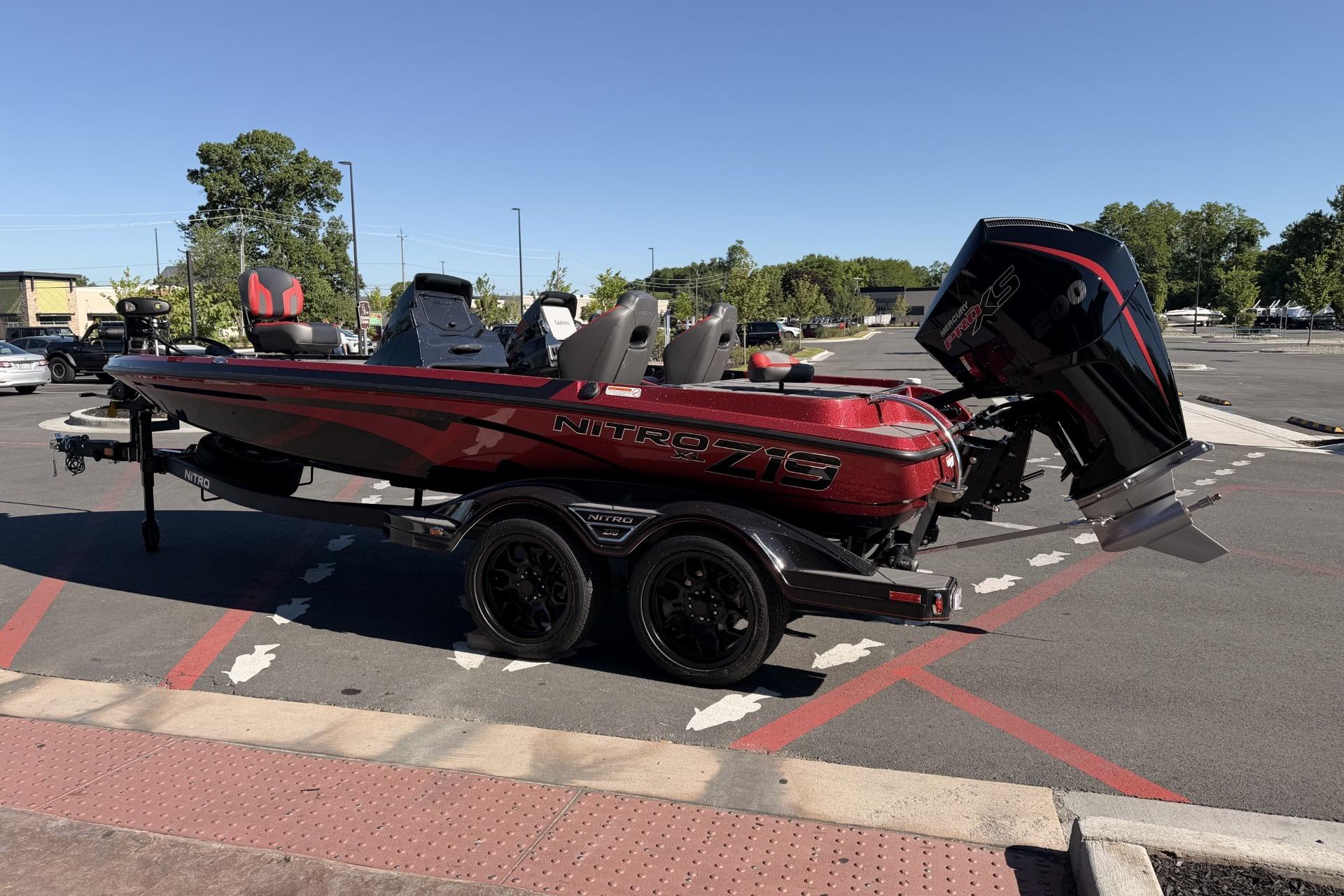 2026 Nitro Z19 XL Pro bass boat with powerful outboard motor in a parking lot.