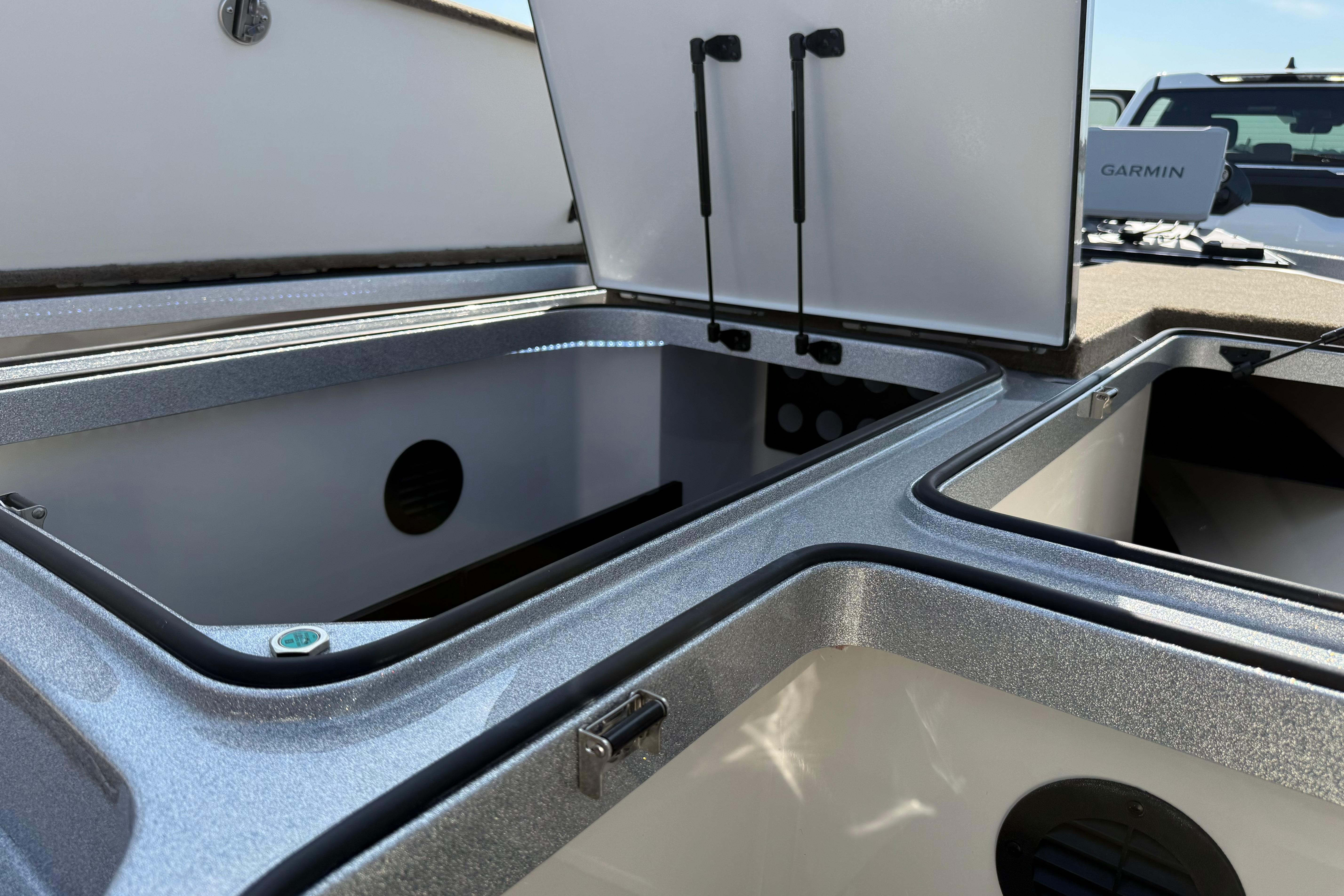Open storage compartments on a 2026 Ranger Z521R boat with Garmin equipment visible.