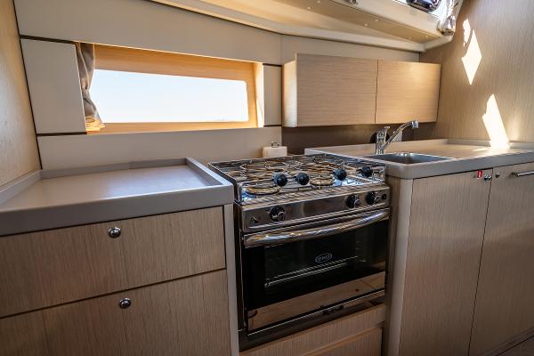 Interior of Beneteau Oceanis 38.1 yacht kitchen, 2021 model.