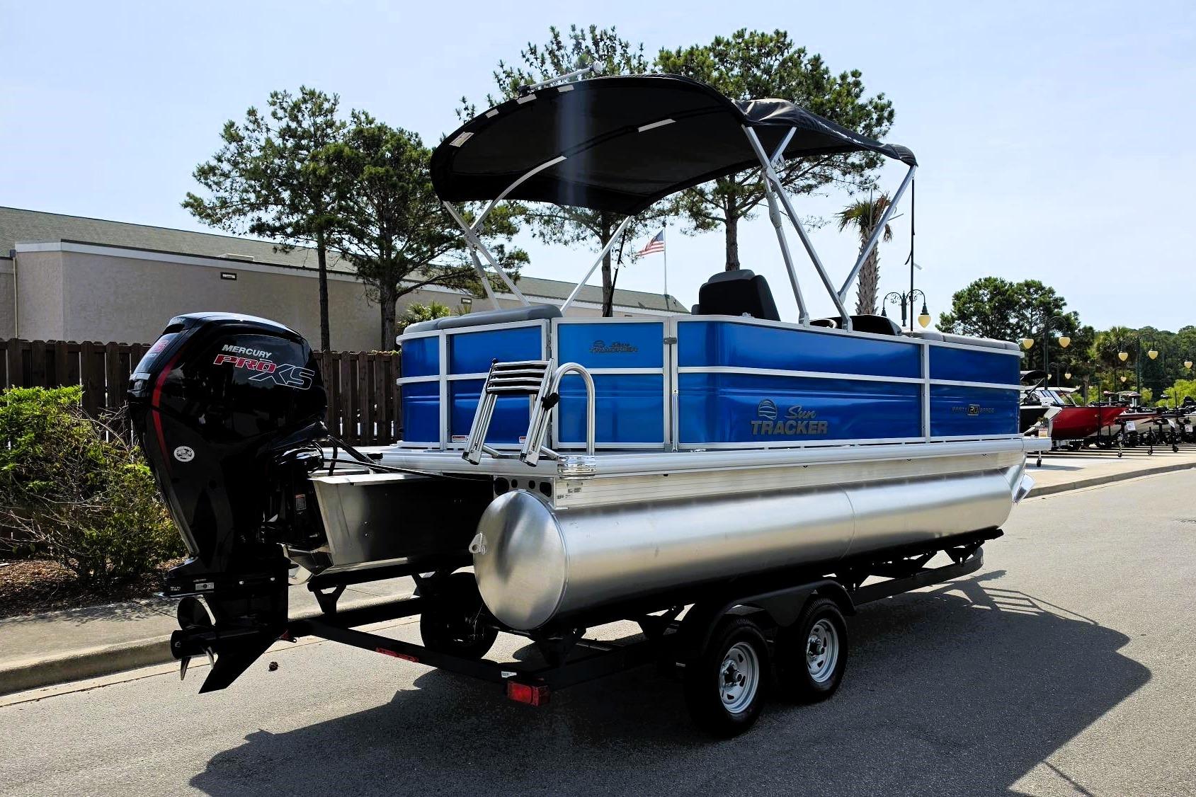 2026 Sun Tracker Party Barge 20 DLX pontoon boat with Mercury Pro XS engine on trailer.