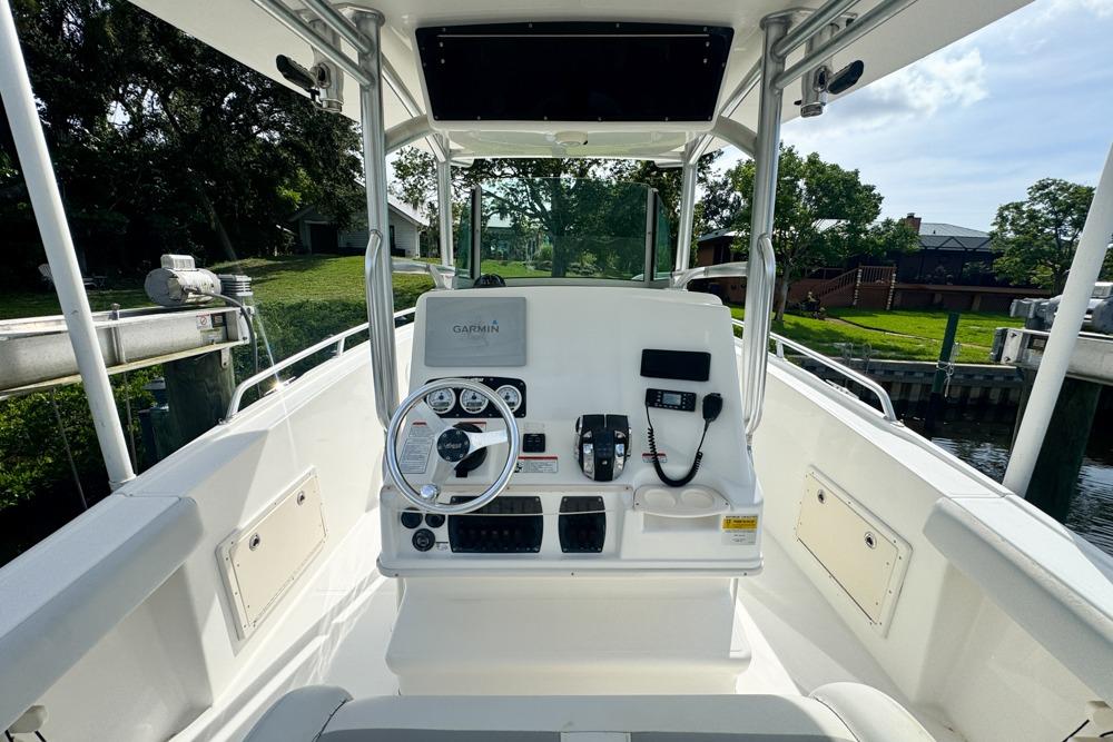 2018 Mako 284 Center Console boat interior with steering wheel and controls.