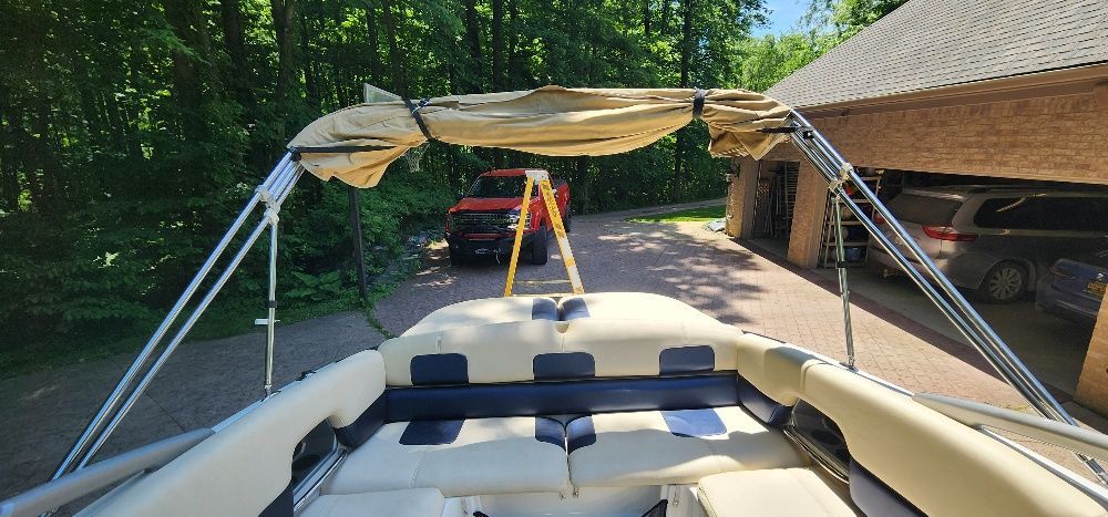 A 2007 Sea-Doo 230 Challenger SE with a folded canopy, parked in a driveway.