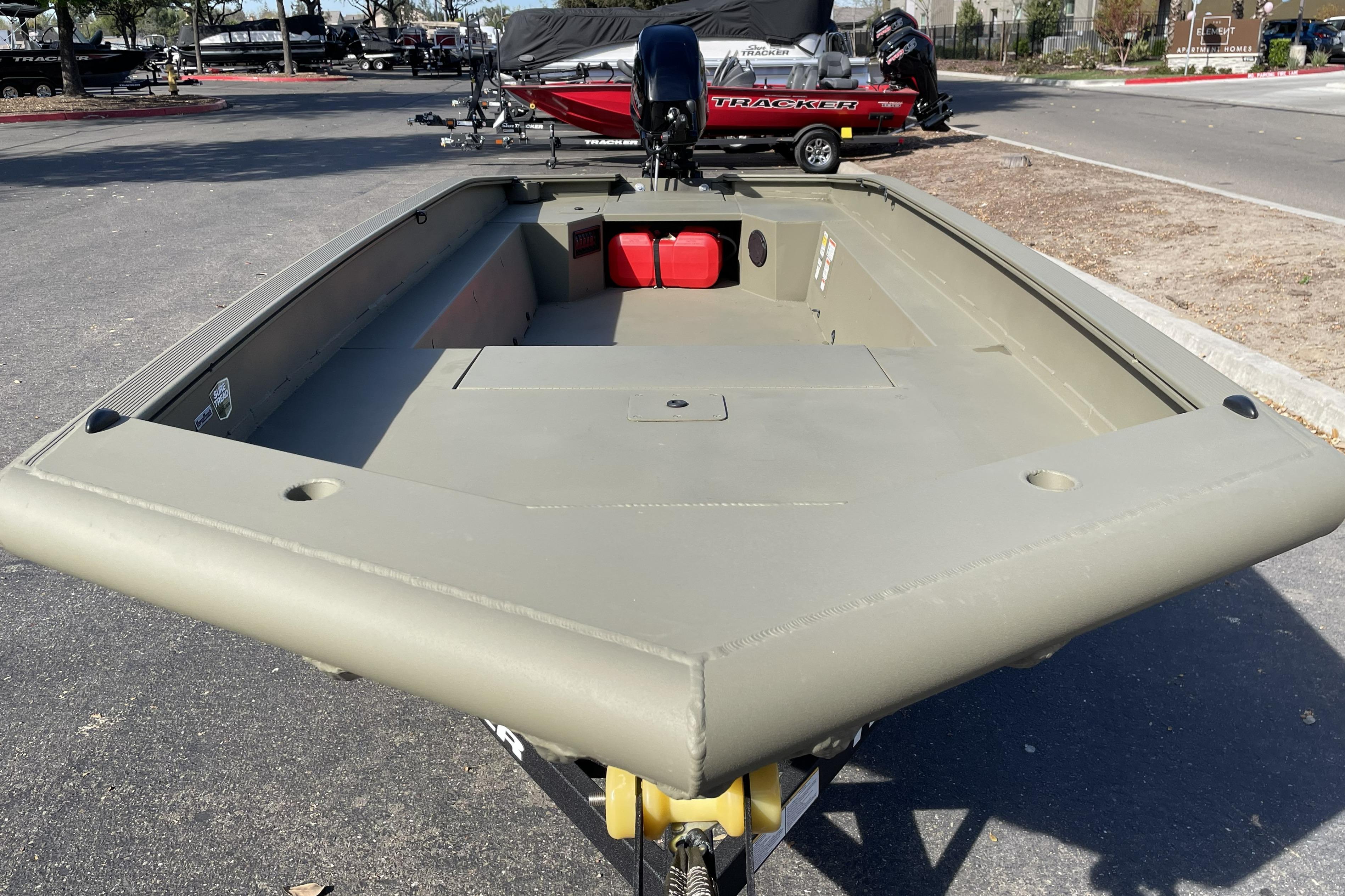 2026 Tracker Grizzly 1650 T Prairie Wings Edition boat on display in a parking lot.