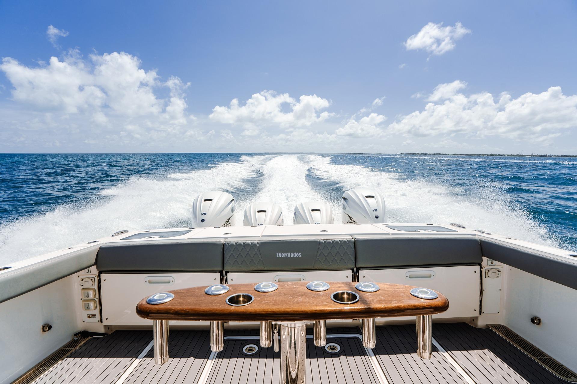 Sleek Everglades 455 Center Console boat cruising on open ocean, 2026 model.
