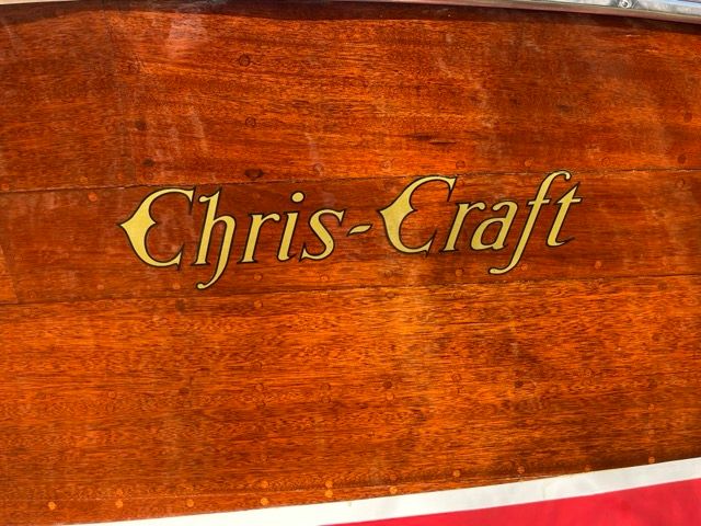 Close-up of the wooden hull of a 1938 Chris-Craft Custom Deluxe Runabout.