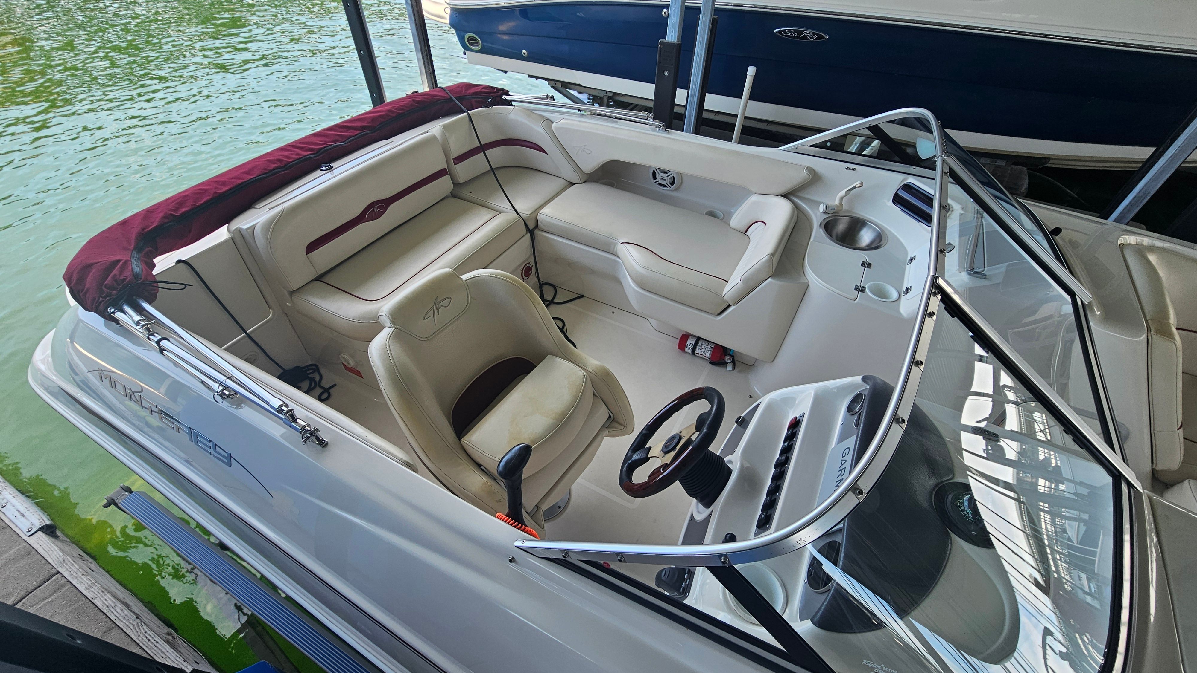 Interior view of a 2002 Monterey 220 Explorer Sport boat with seating and helm.