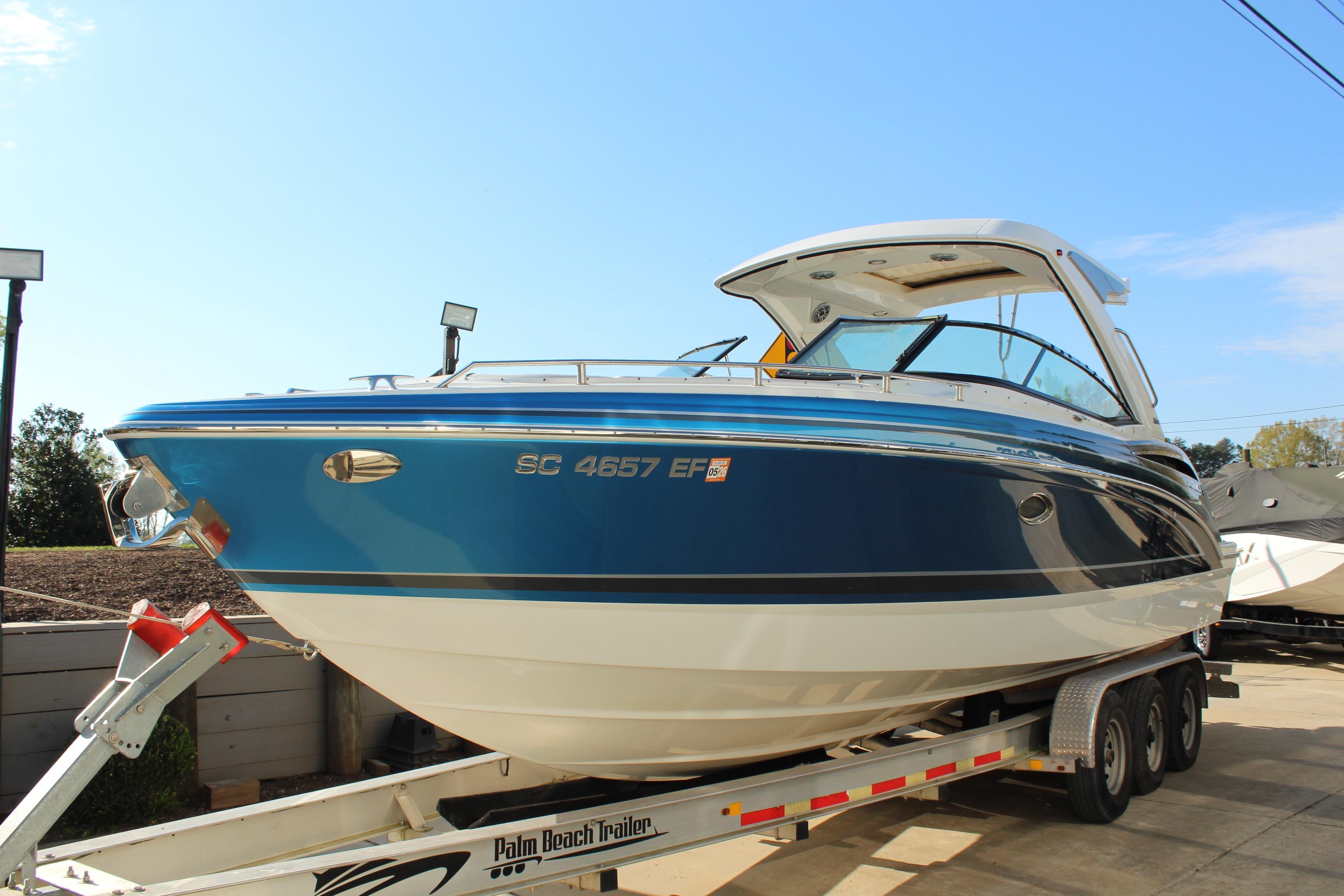 2023 Formula 310 Bowrider I/O boat on trailer, blue and white exterior.