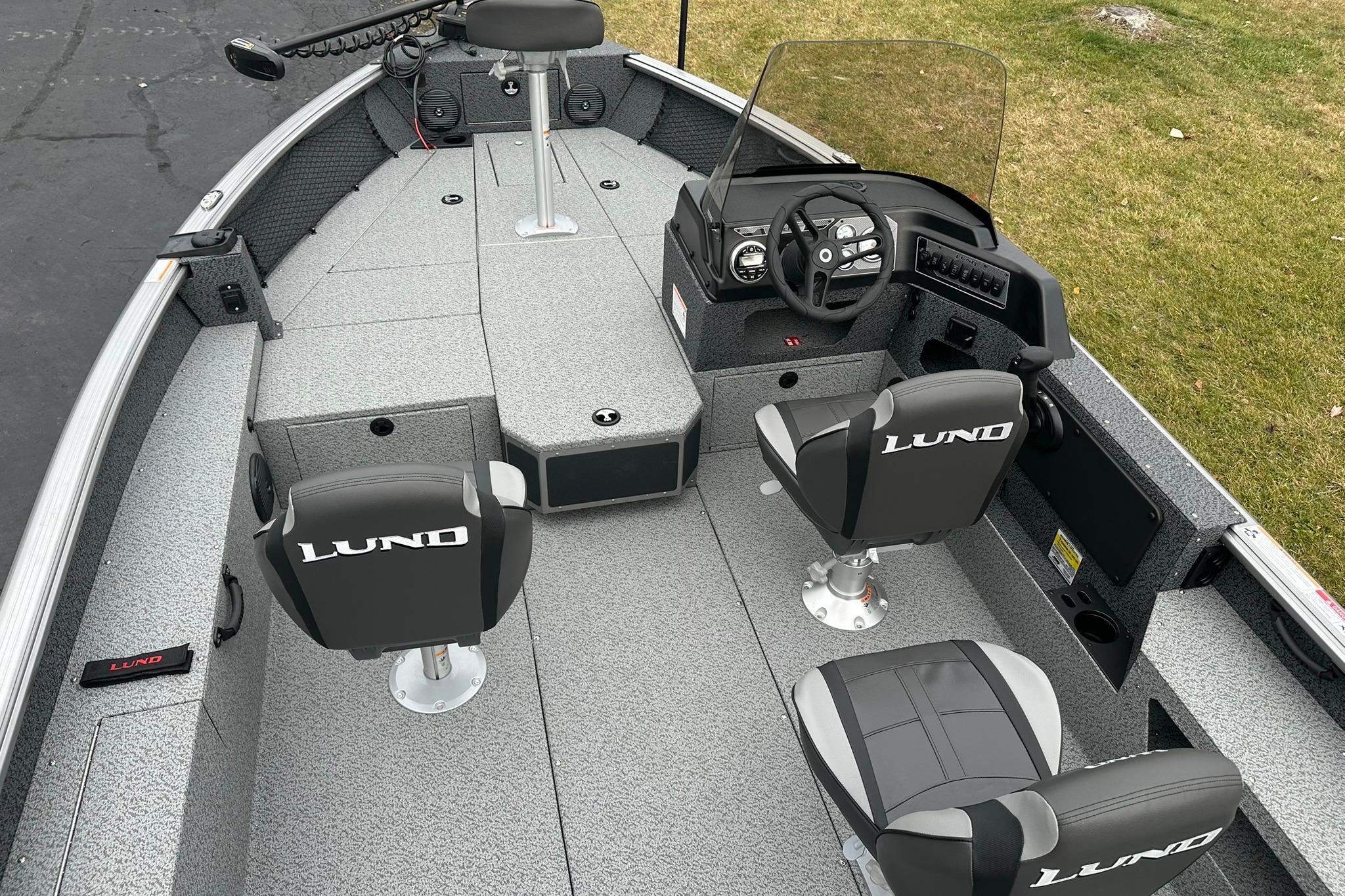 2026 Lund 1875 Impact XS SS boat interior with steering console and seating.