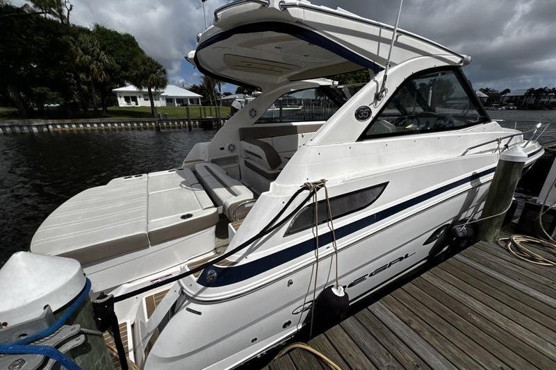 2018 Regal 35 Sport Coupe docked by a wooden pier under cloudy skies.