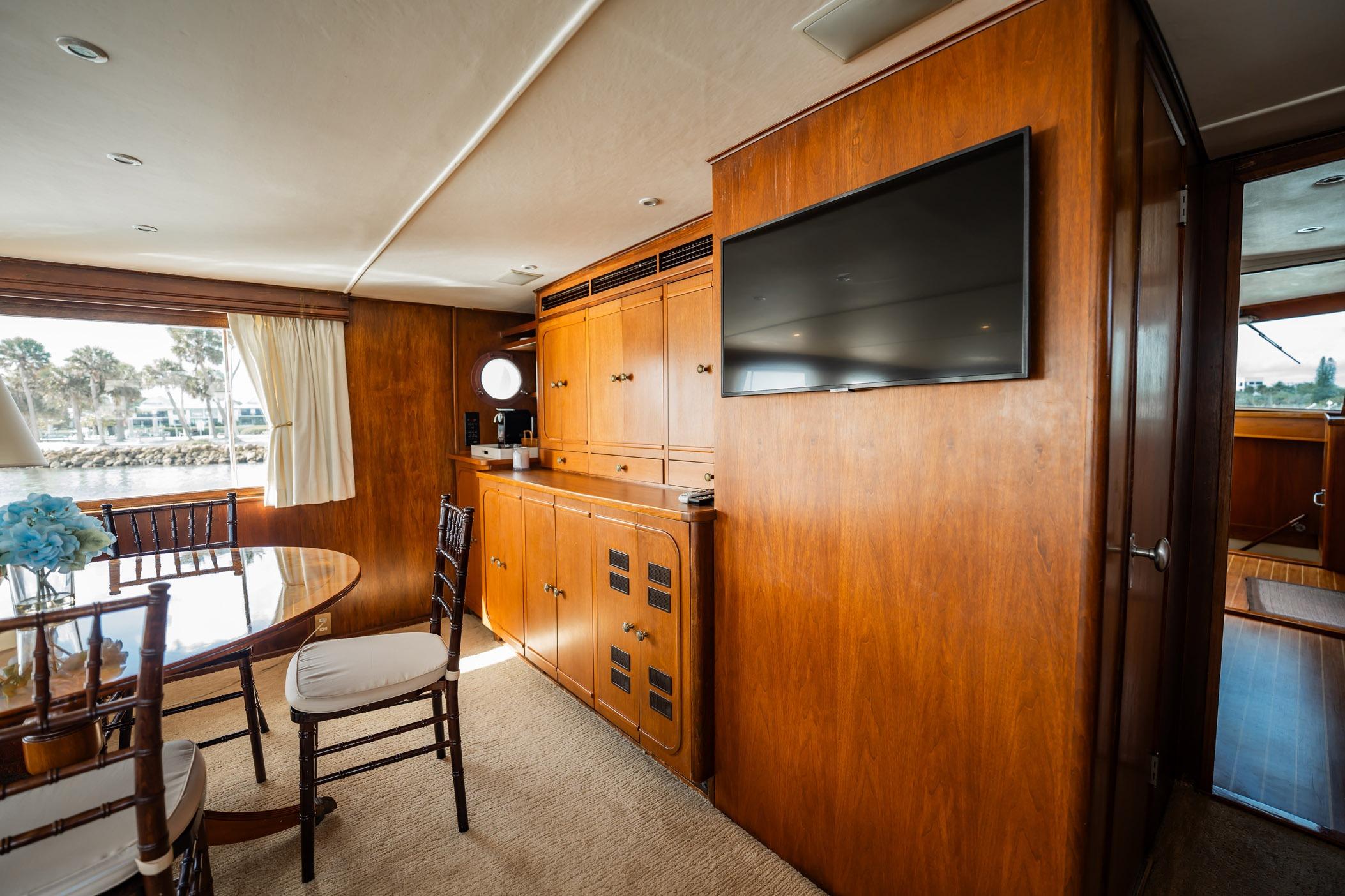 Luxurious interior of 1972 Trumpy 72 Motor Yacht with wood paneling and elegant furnishings.