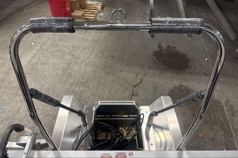 2026 Bennington 22 SSRSF boat ladder with chrome finish and protective padding.