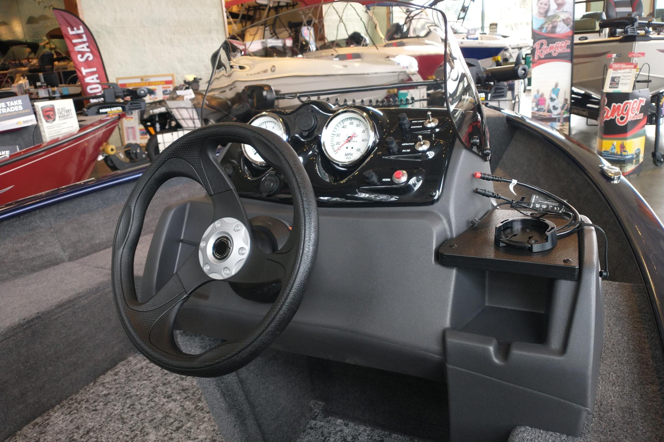 2026 Tracker Super Guide V-16 SC boat dashboard with steering wheel and gauges.
