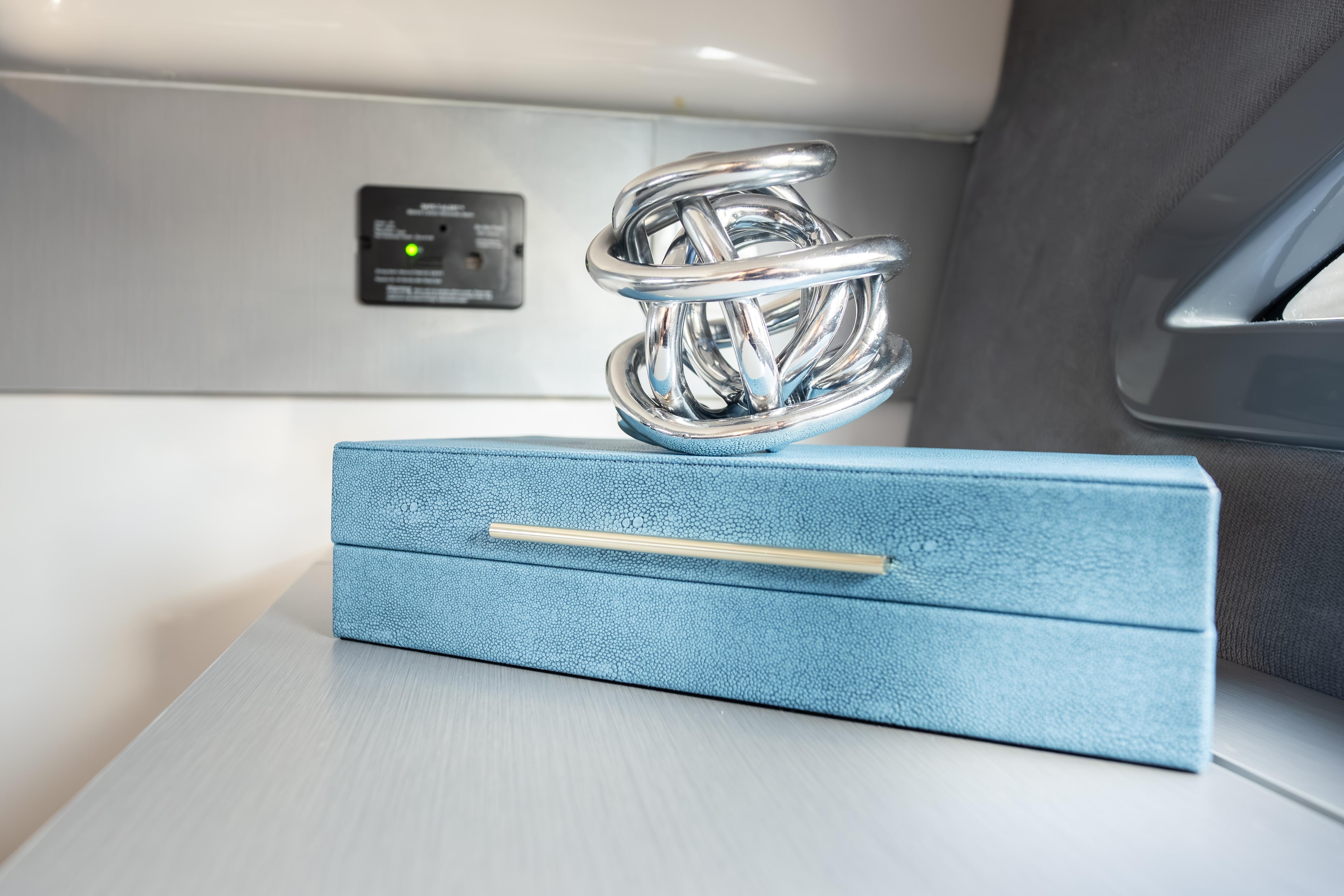 Silver sculpture on blue box inside Hanover 347, 2026 model.