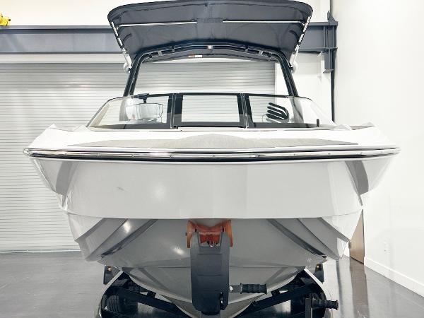 2025 Supreme S240 boat in showroom, front view, sleek design, black canopy.