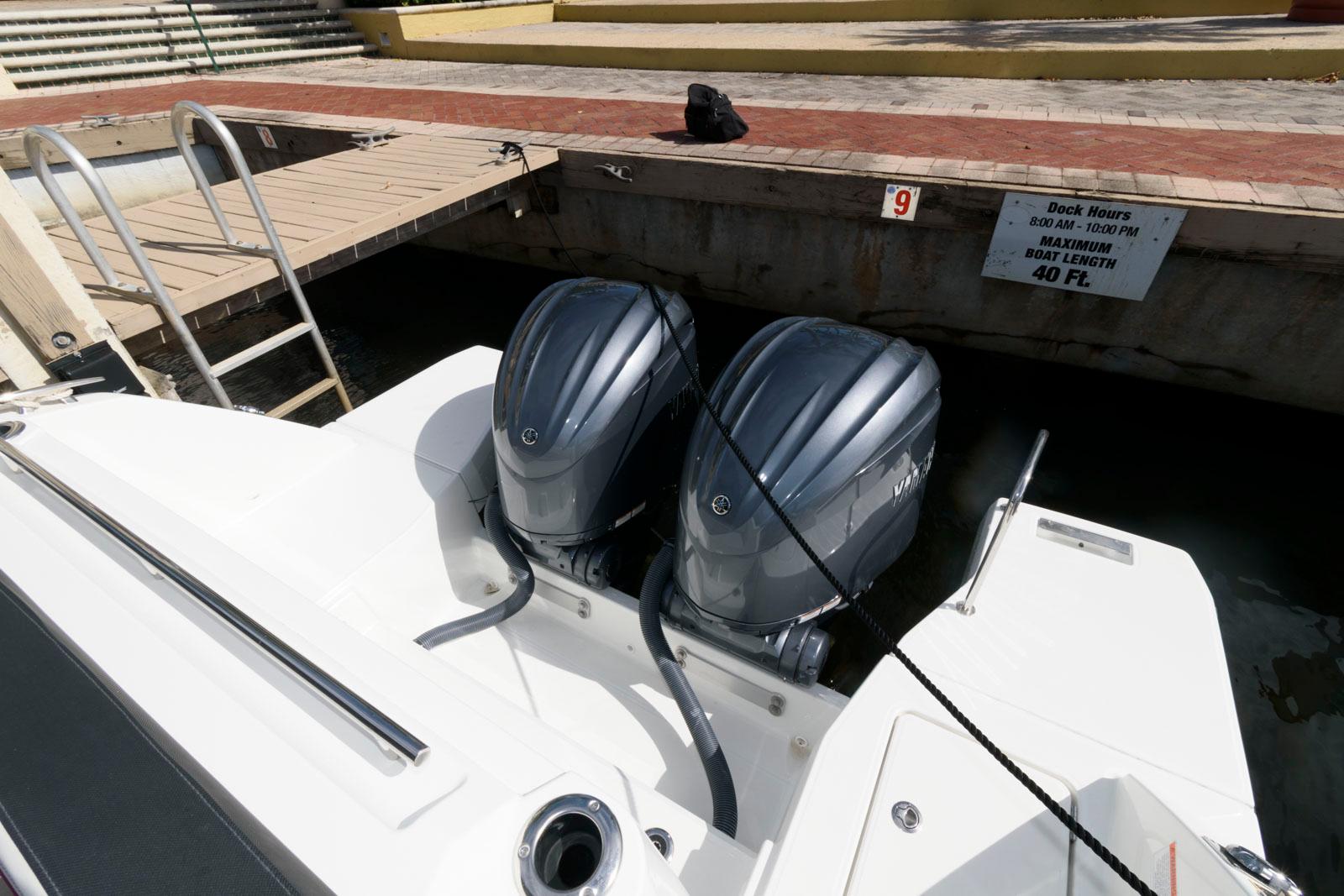 2023 Jeanneau Leader 10.5 CC with dual outboard engines docked at marina.