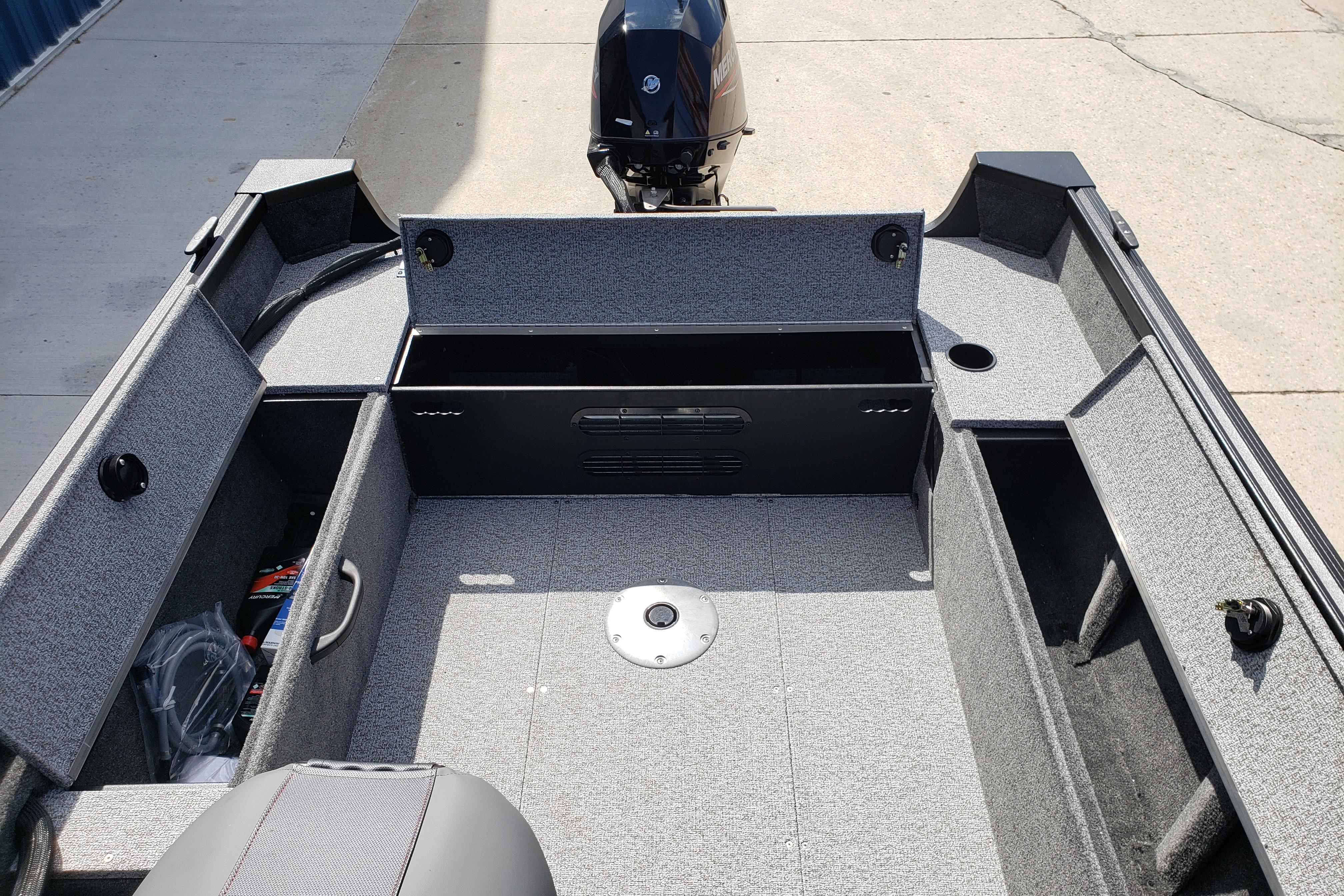 2026 Alumacraft Escape 165 CS boat interior with storage compartments and motor.