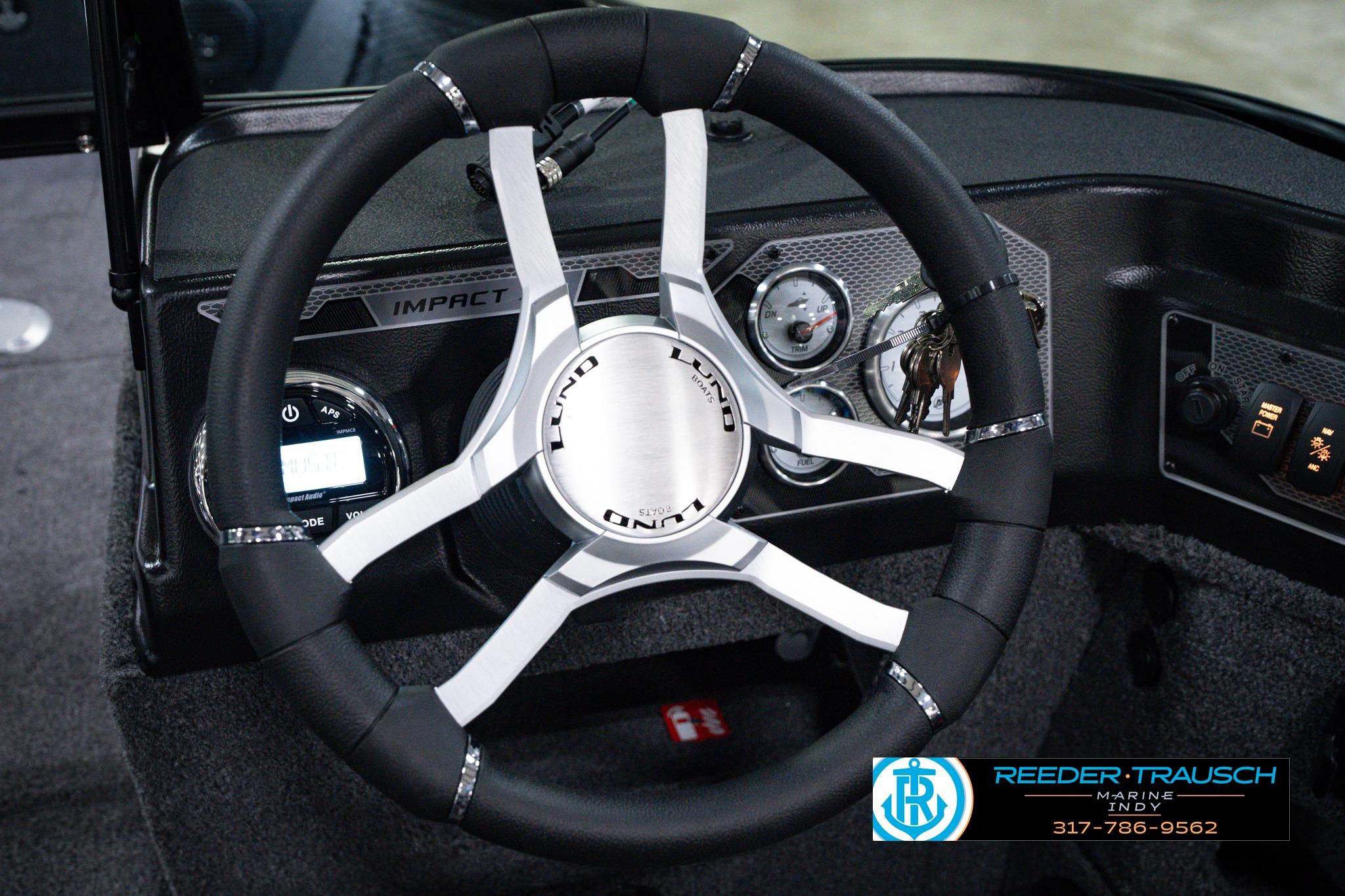Steering wheel of 2026 Lund 1875 Impact XS SS boat with dashboard controls.