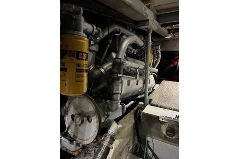 Engine room of 1985 Ocean Yachts 38 Super Sport, showcasing mechanical components.