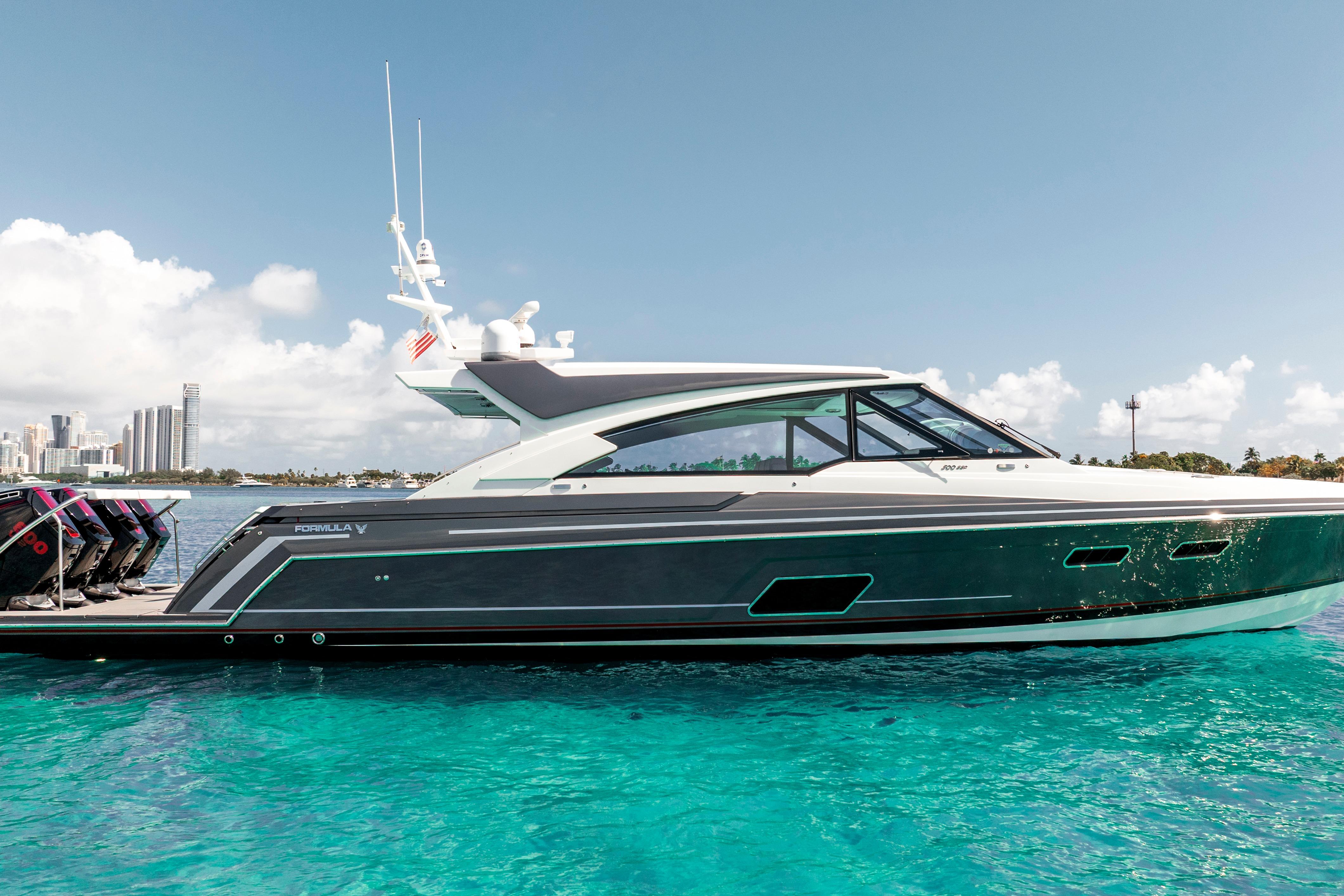 2022 Formula 500 Super Sport Crossover yacht on clear blue water, city skyline in background.