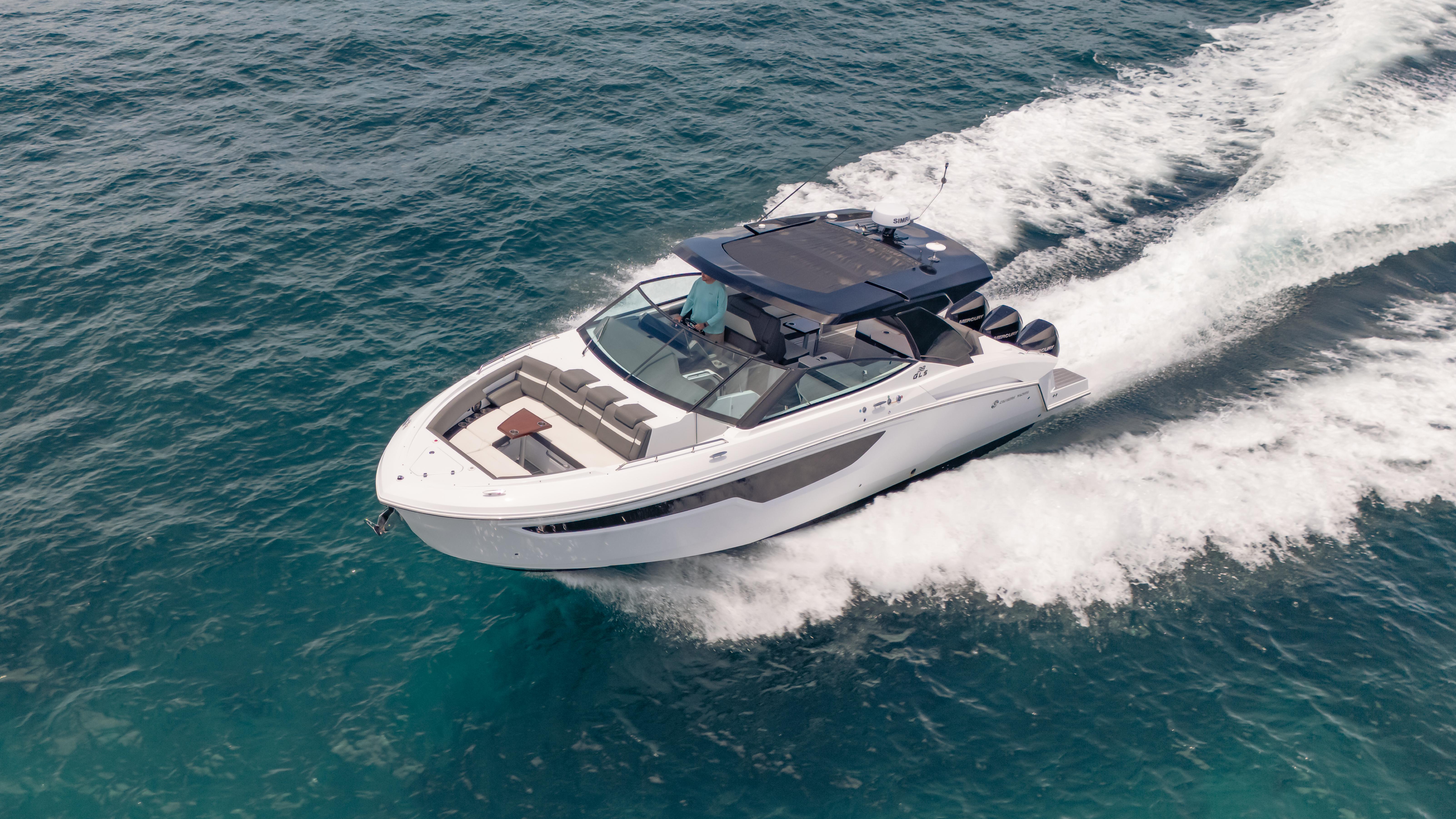 2021 Cruisers Yachts 38 GLS speeding on open water, showcasing sleek design and performance.