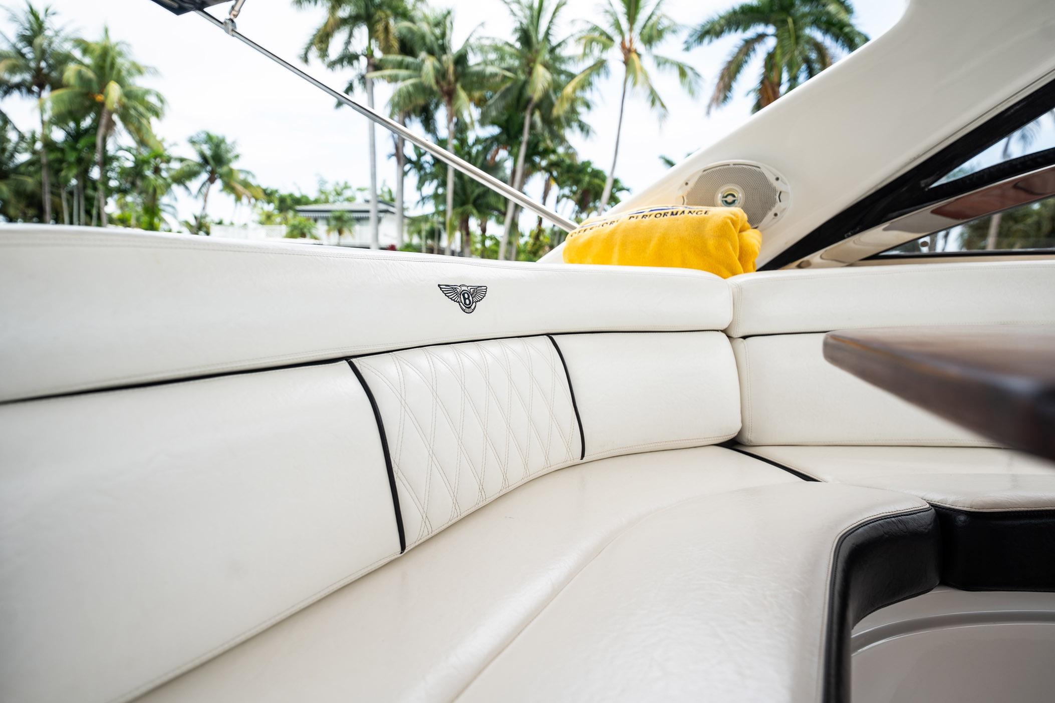 Luxurious interior of 2008 Regal Commodore 4460 yacht with white leather seating.