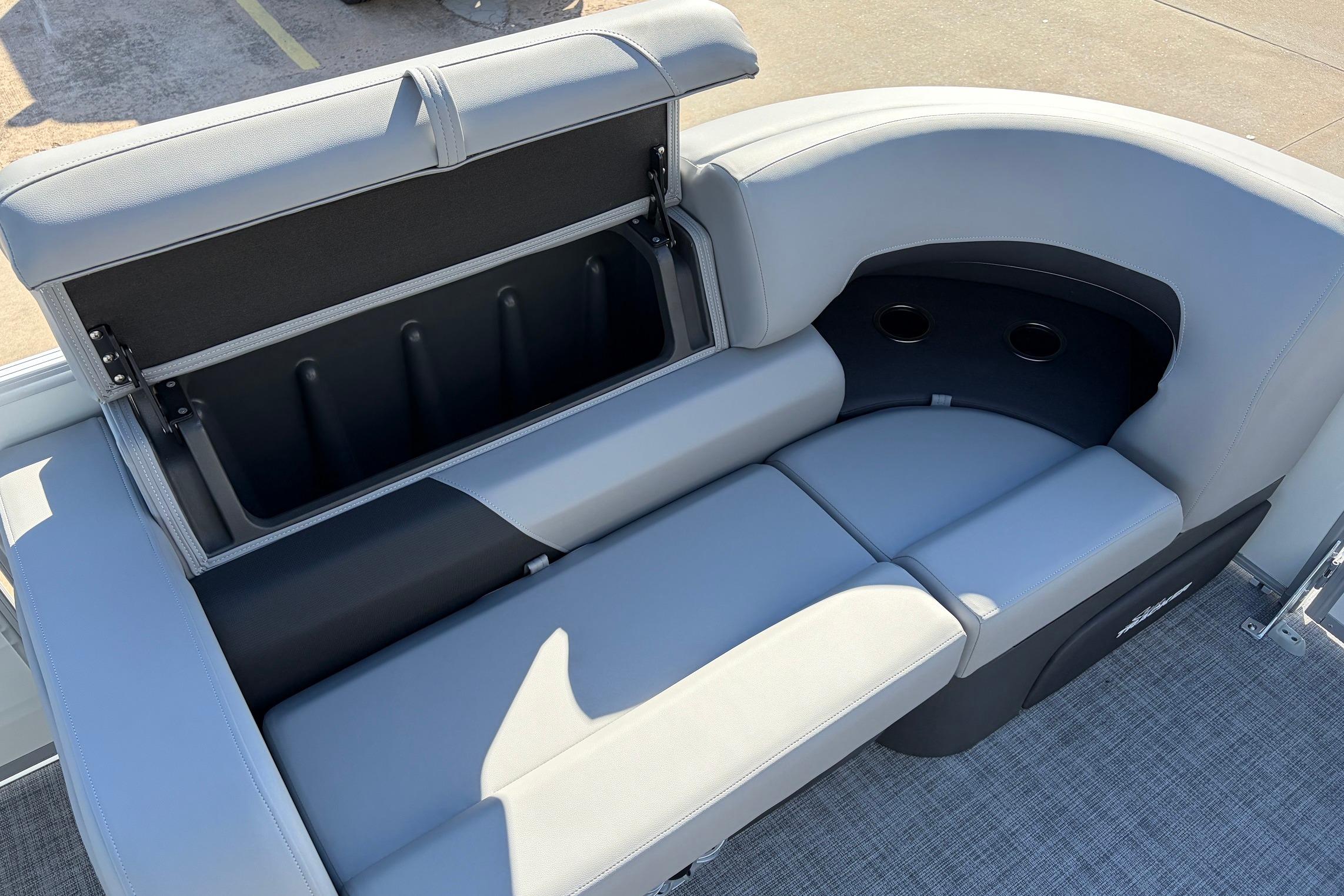 2026 Sun Tracker Party Barge 22 RF XP3 seating with storage compartment and cup holders.