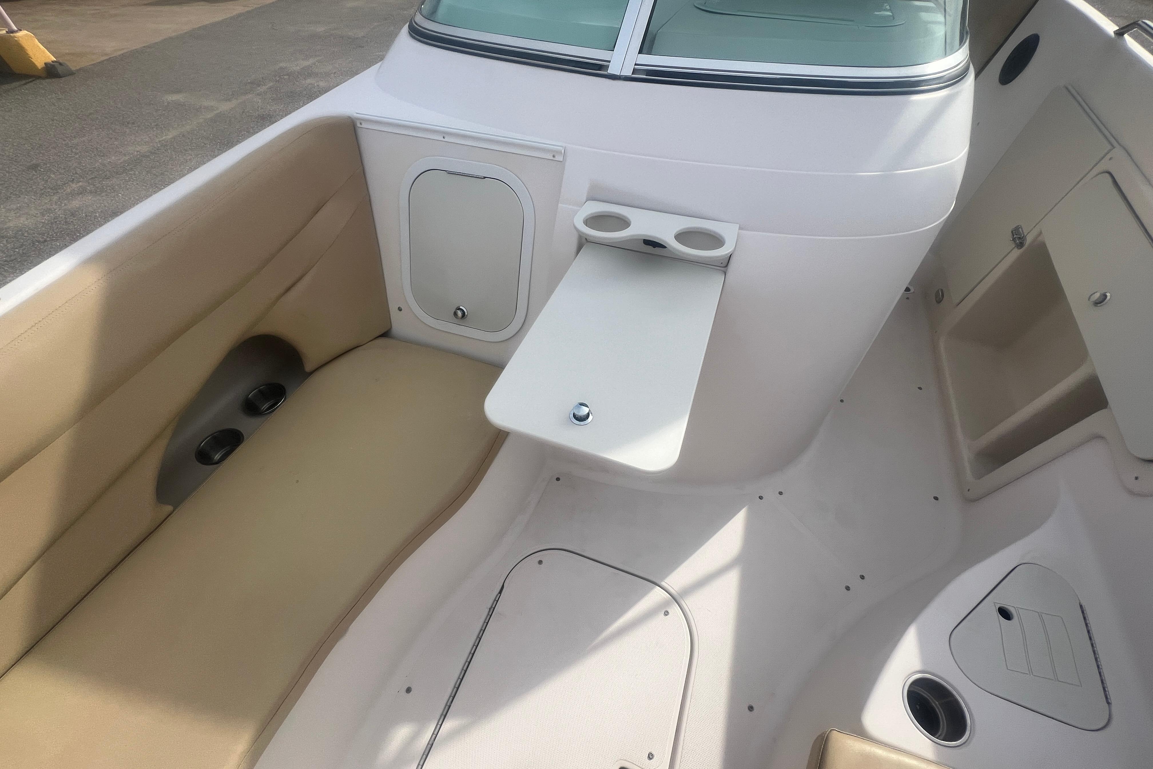 2002 Hurricane SunDeck 260 OB boat interior with seating and cup holders.