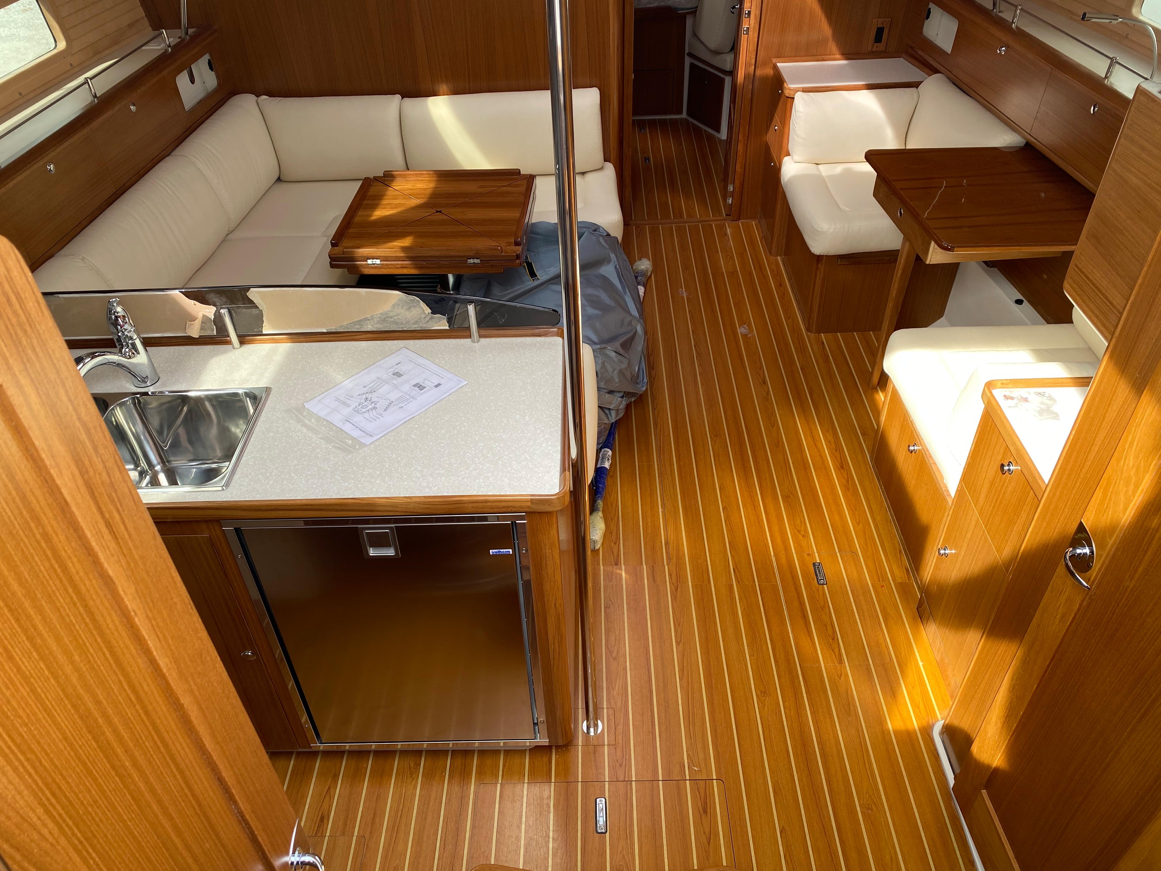 Luxurious interior of 2026 Catalina 426 yacht with wood flooring and cozy seating.