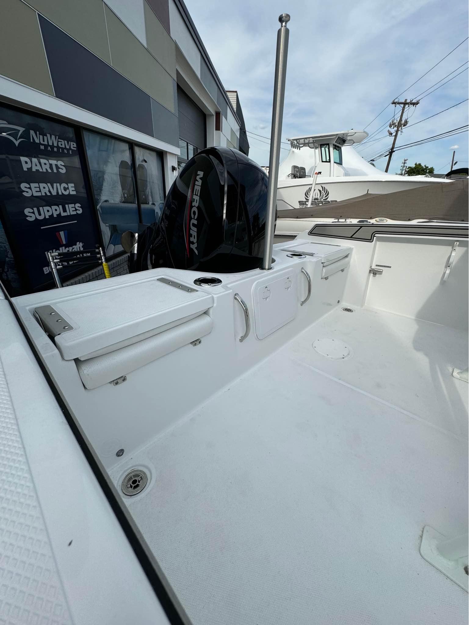 2025 Wellcraft 202 Fisherman boat interior with Mercury outboard motor at a dealership.