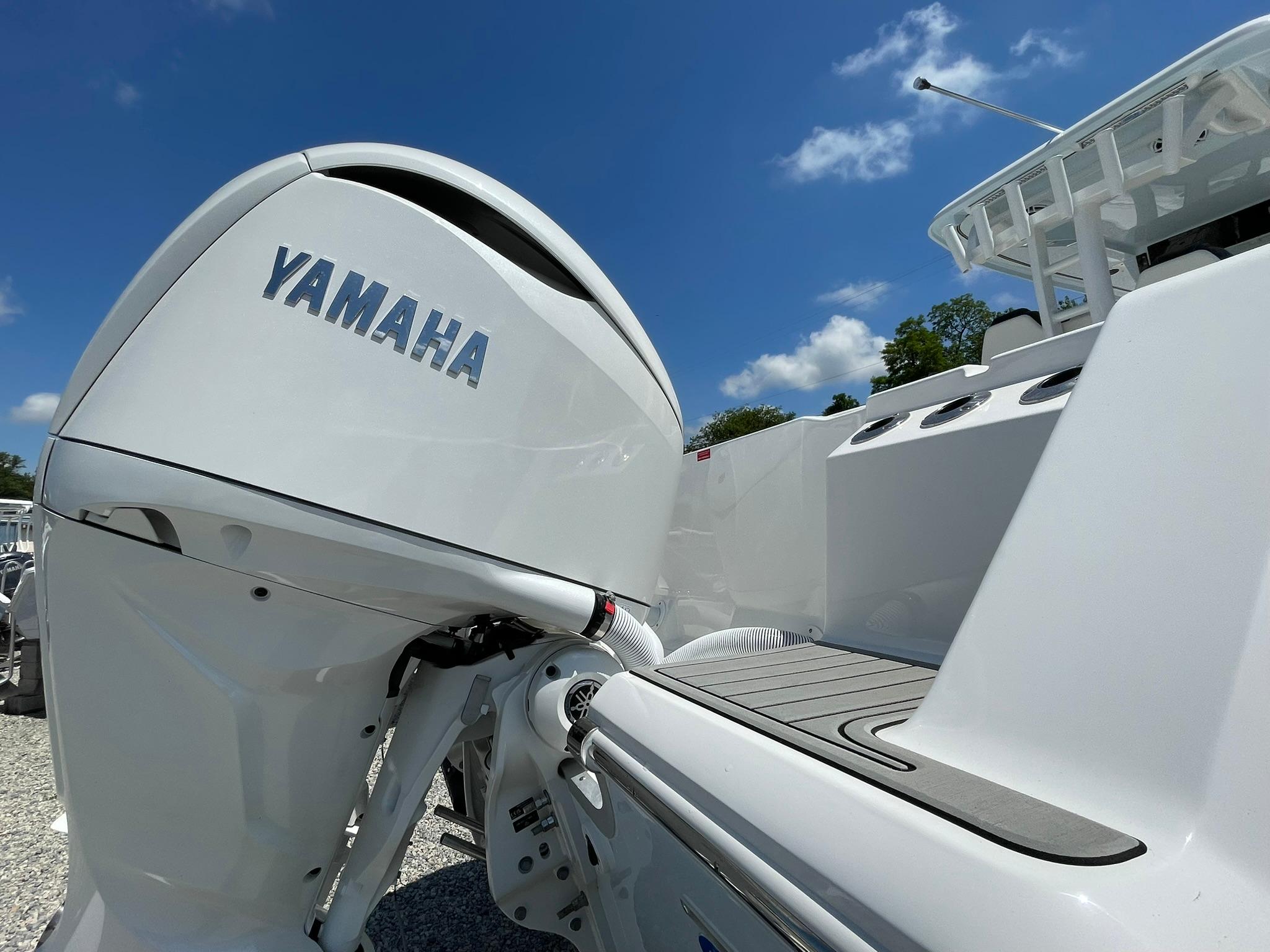 2026 Tidewater 302 CC Adventure boat with Yamaha outboard motor under clear blue sky.