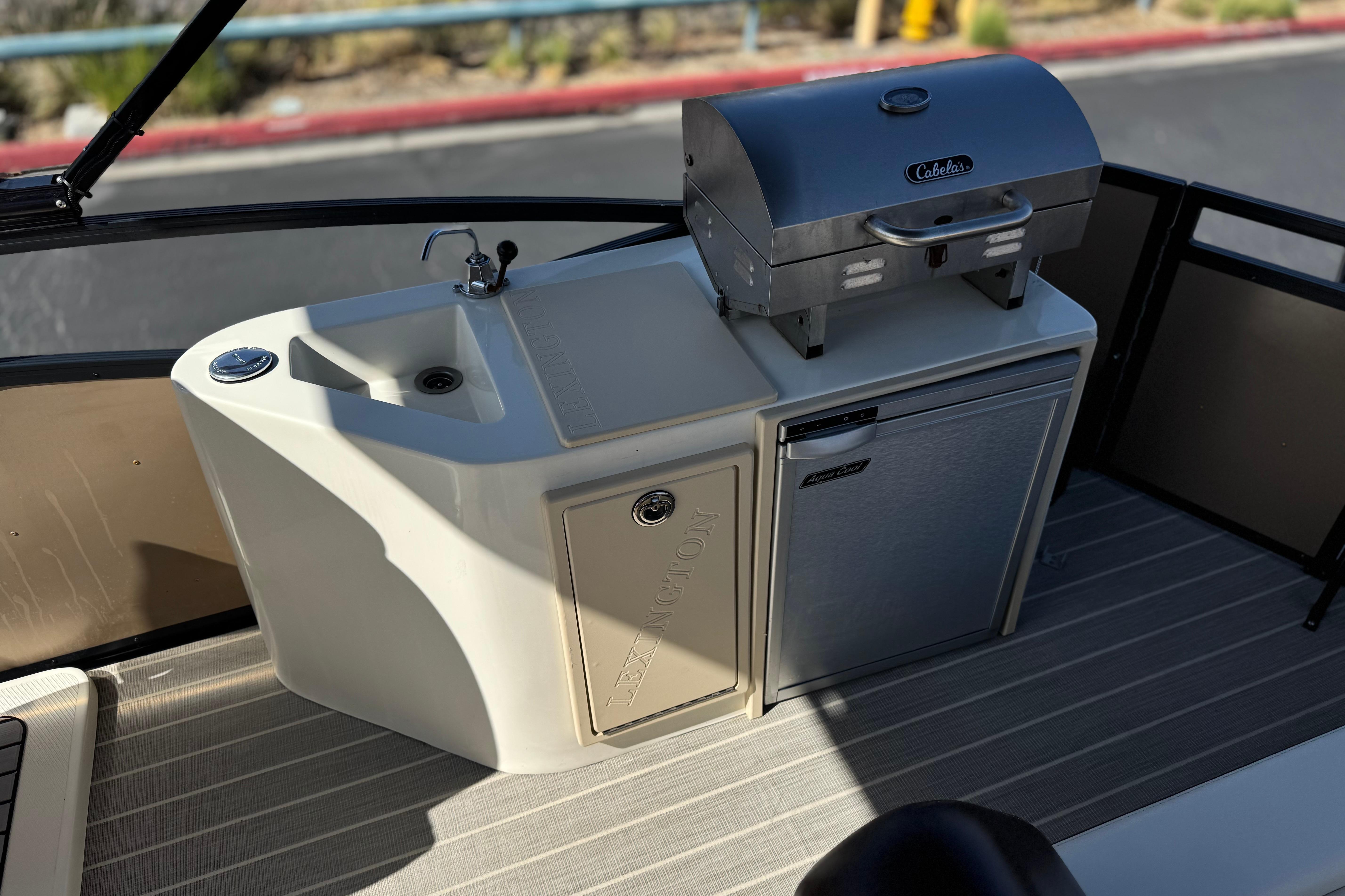Outdoor kitchen setup on 2023 Lexington 623 ST Xtreme boat with grill and sink.