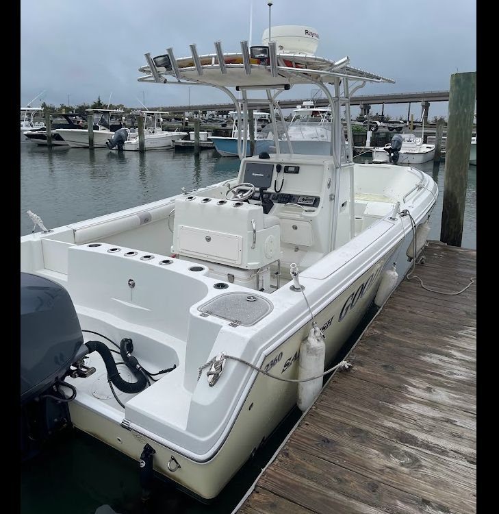 2006 Sailfish 2360 CC boat docked at marina.