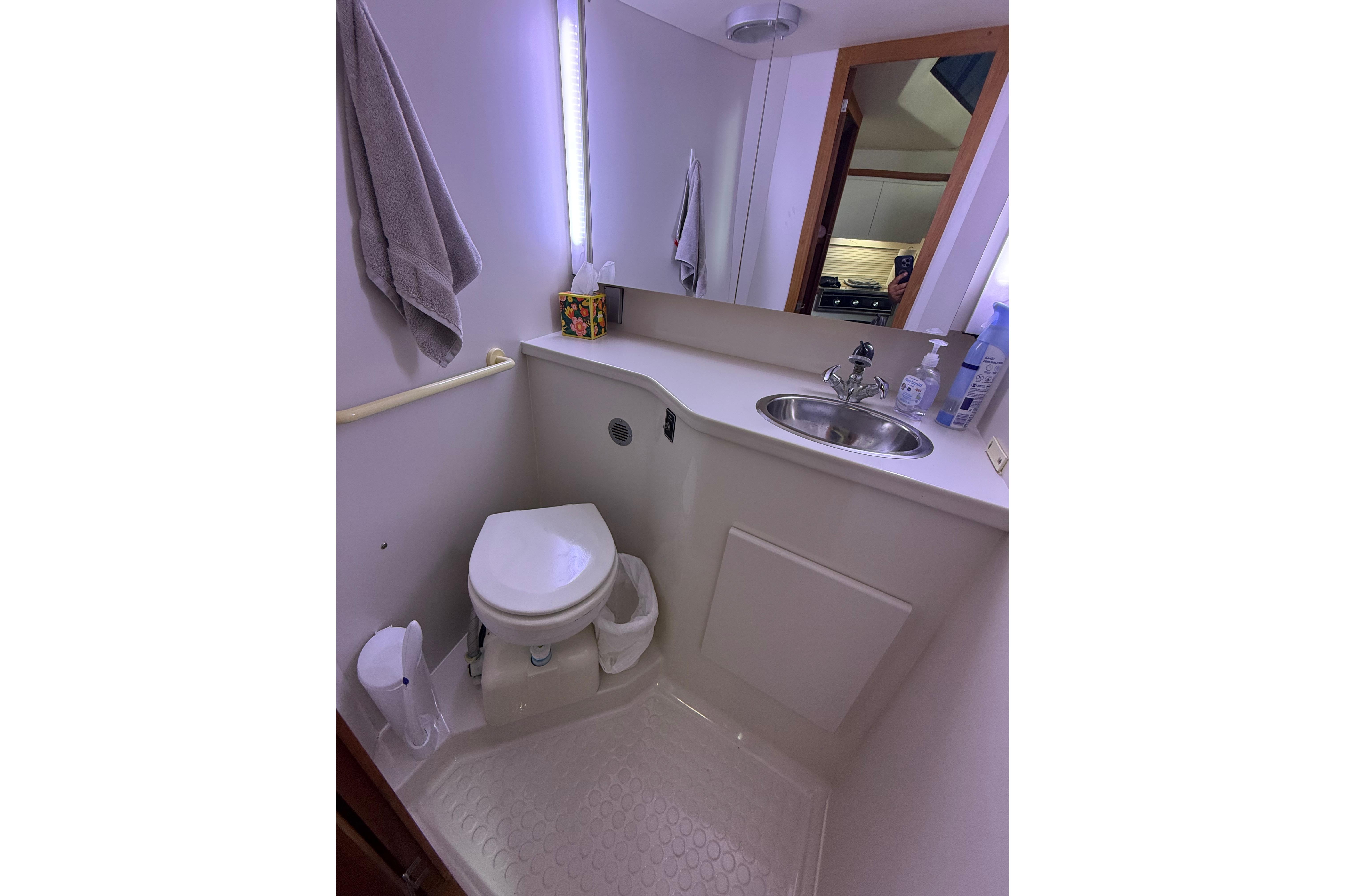 Bathroom interior of 1992 Carver 33 Aft Cabin Motor Yacht with sink and toilet.