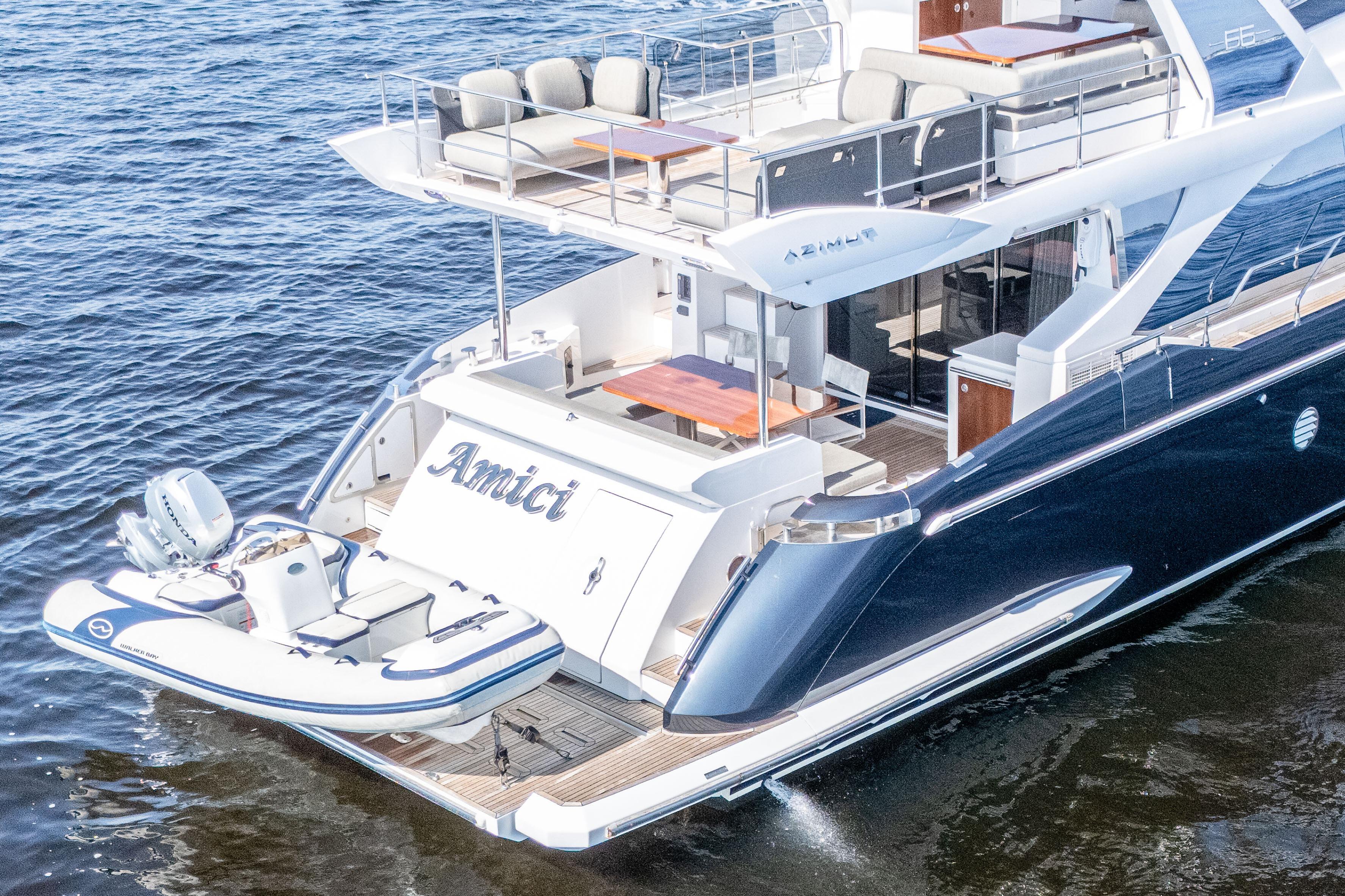 2017 Azimut 66 Flybridge yacht on water, featuring spacious deck and tender boat.