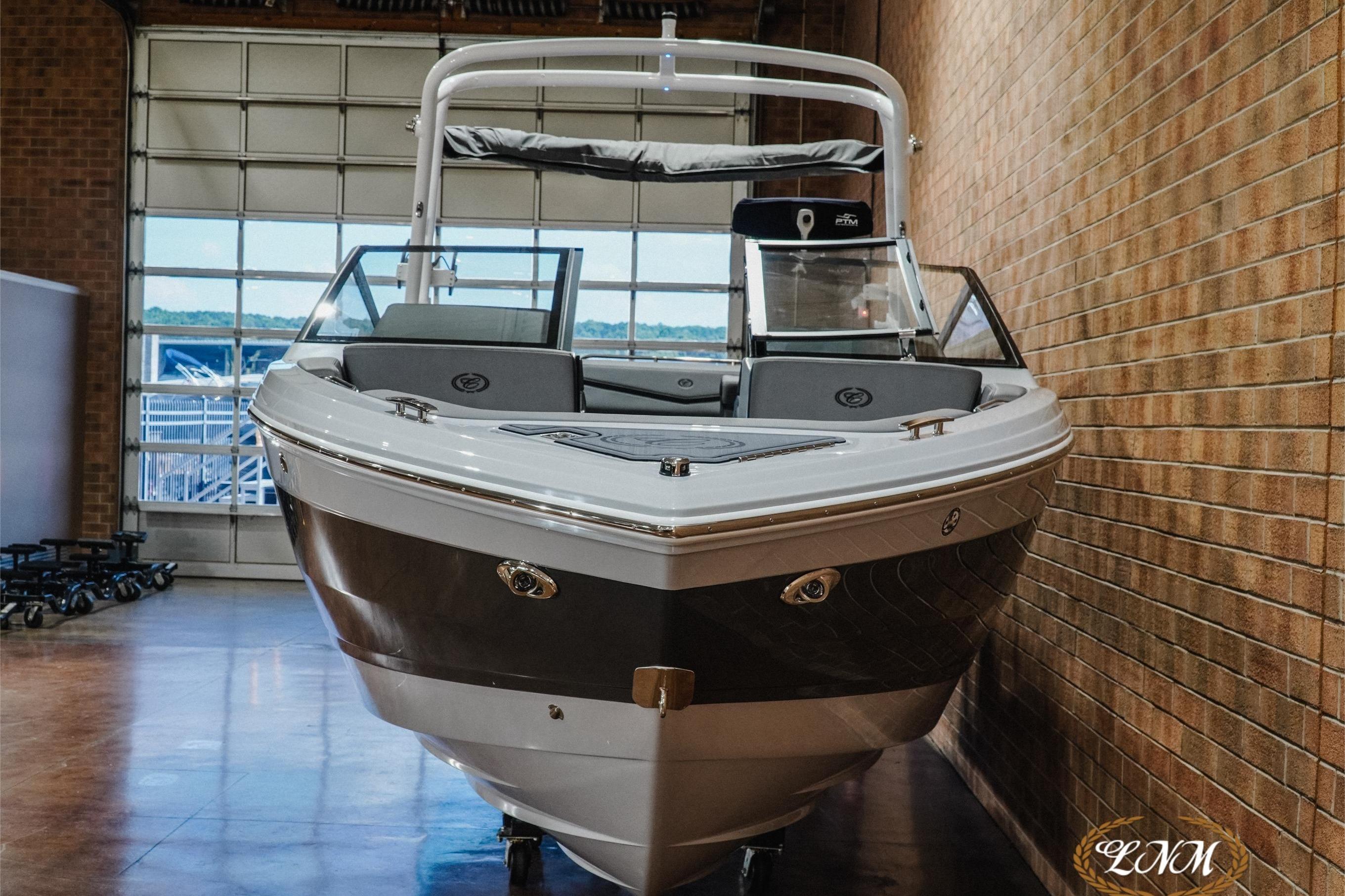 2026 Cobalt R4 Surf boat in showroom, showcasing sleek design and modern features.