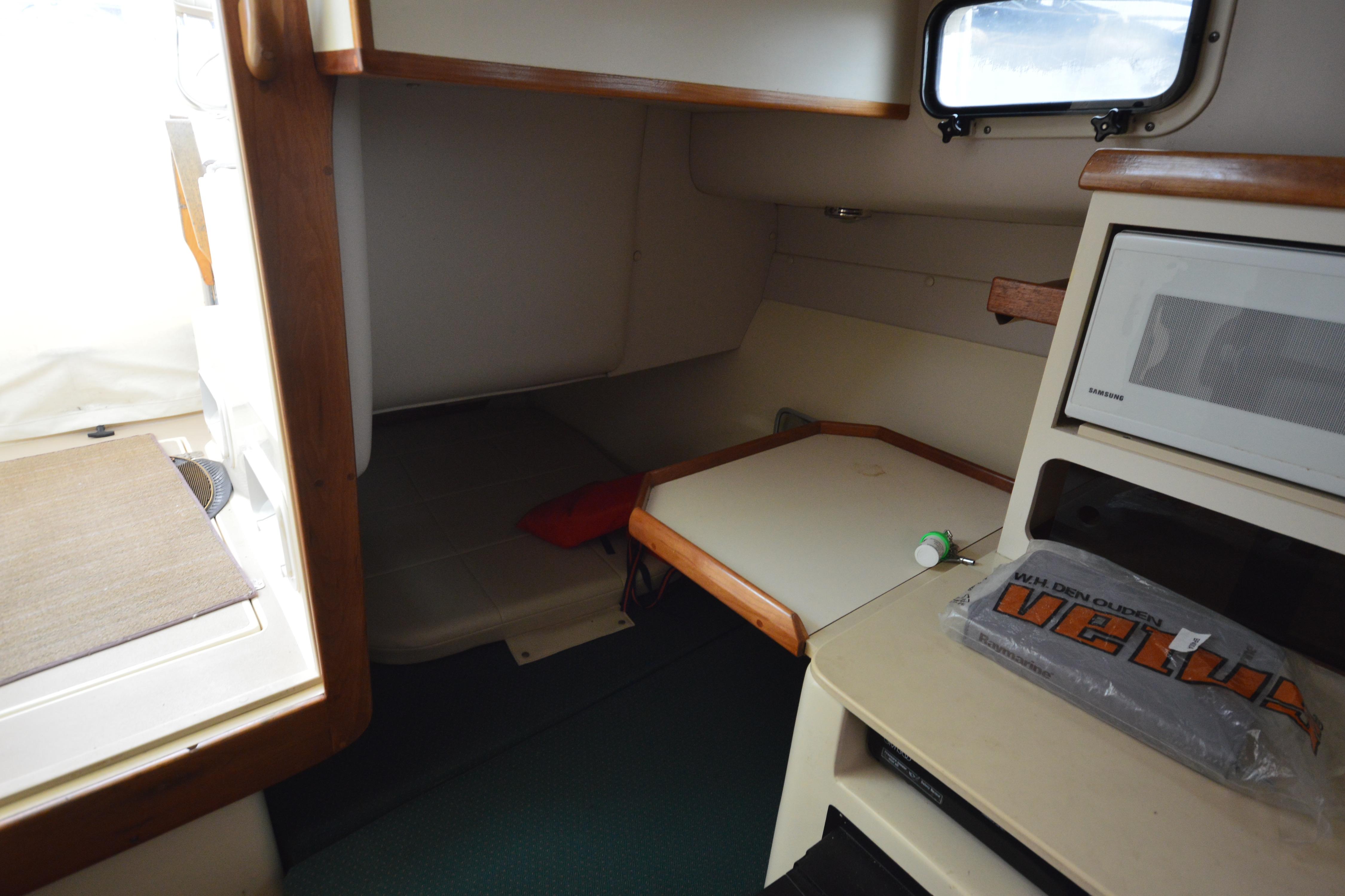 2001 Albin 28 Tournament Express cabin interior with microwave and seating area.