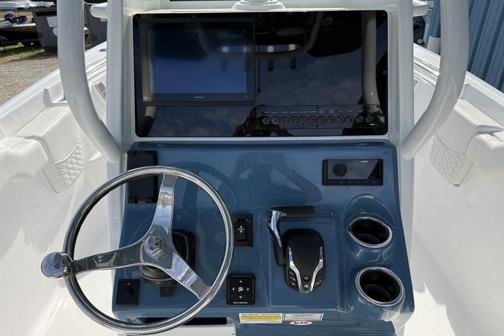 Helm of 2026 Tidewater 232 LXF boat with steering wheel and control panel.