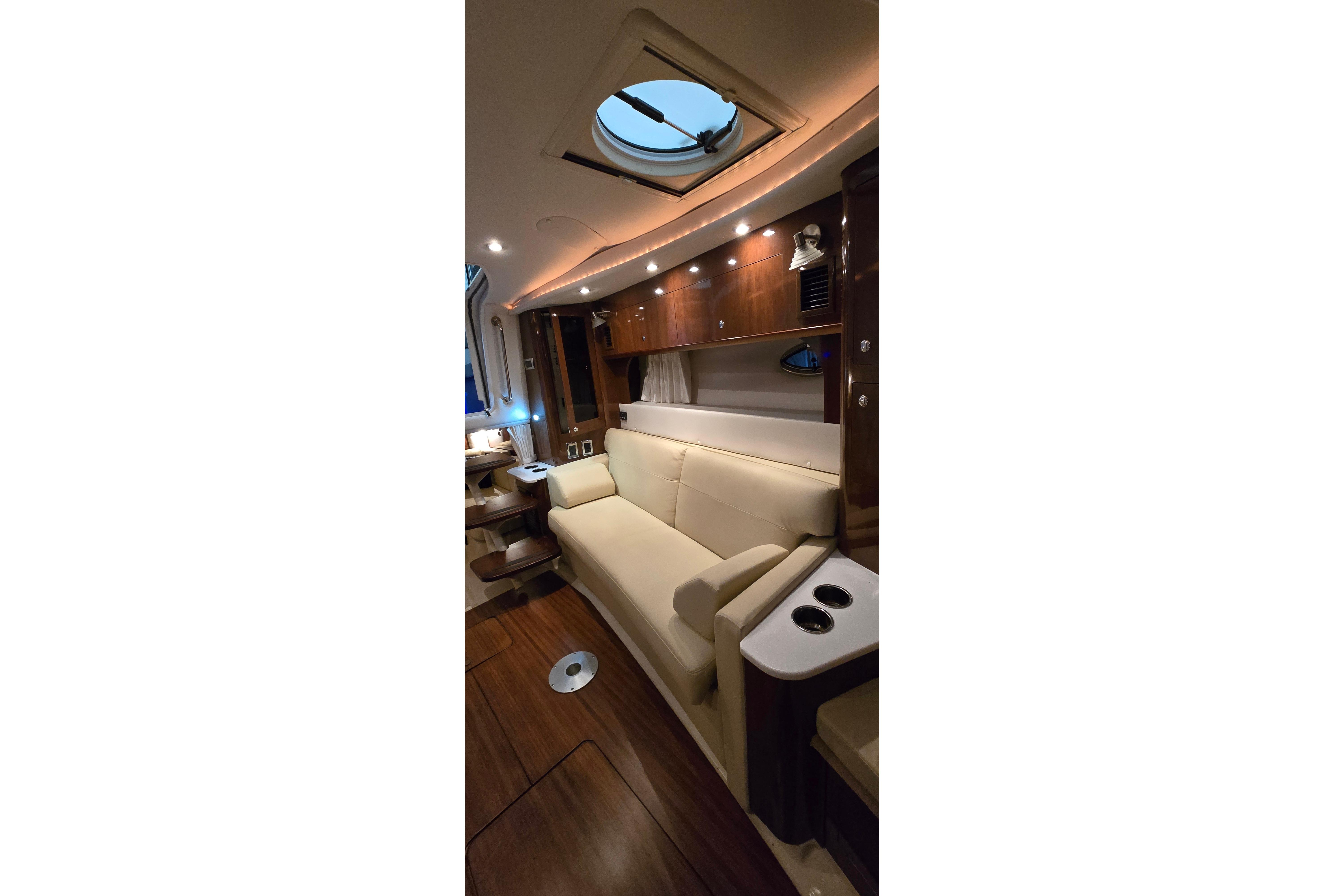 Luxurious interior of 2018 Four Winns V355 yacht with elegant seating and ambient lighting.