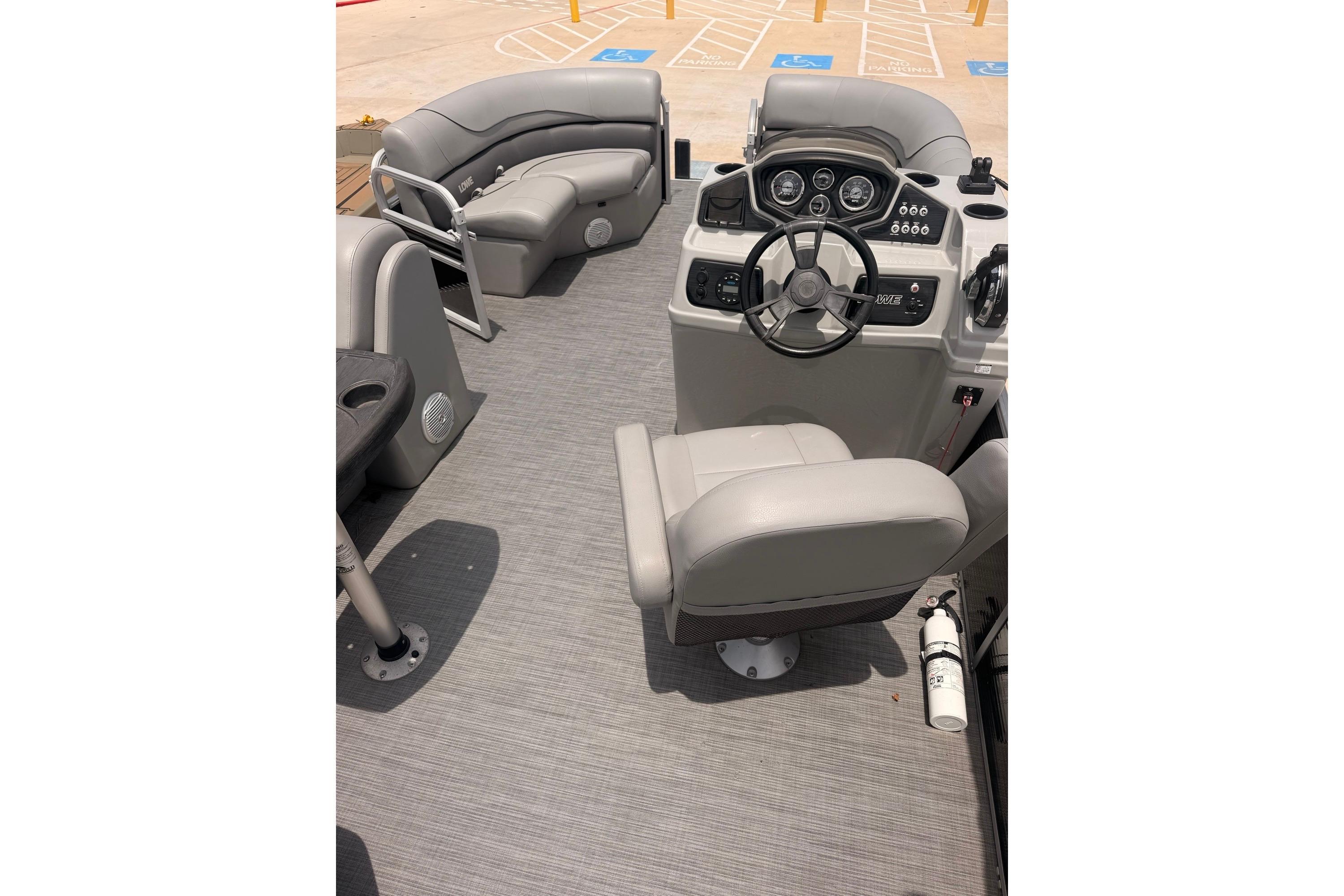 Interior of a 2021 Lowe SS 210 boat with steering console and seating.