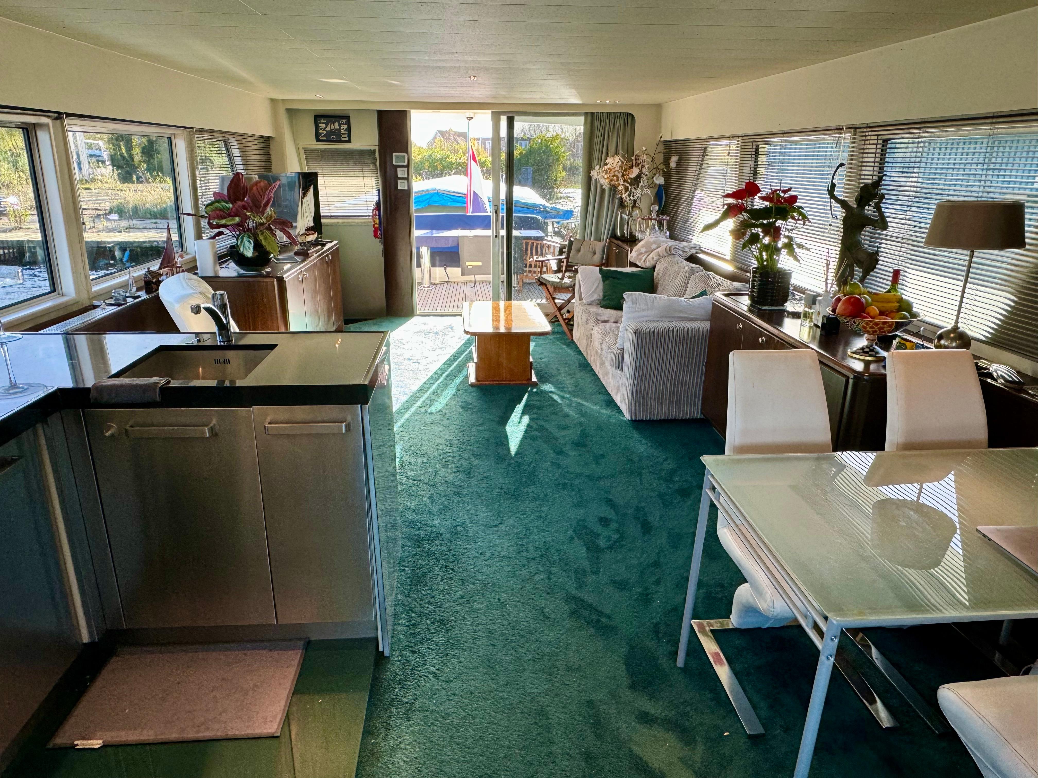 Luxurious interior of a 1987 Moonen 72 yacht with modern kitchen and elegant seating area.