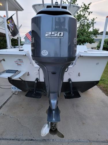 2011 Carolina Skiff 258 DLV with Yamaha 250 outboard motor, parked on driveway.