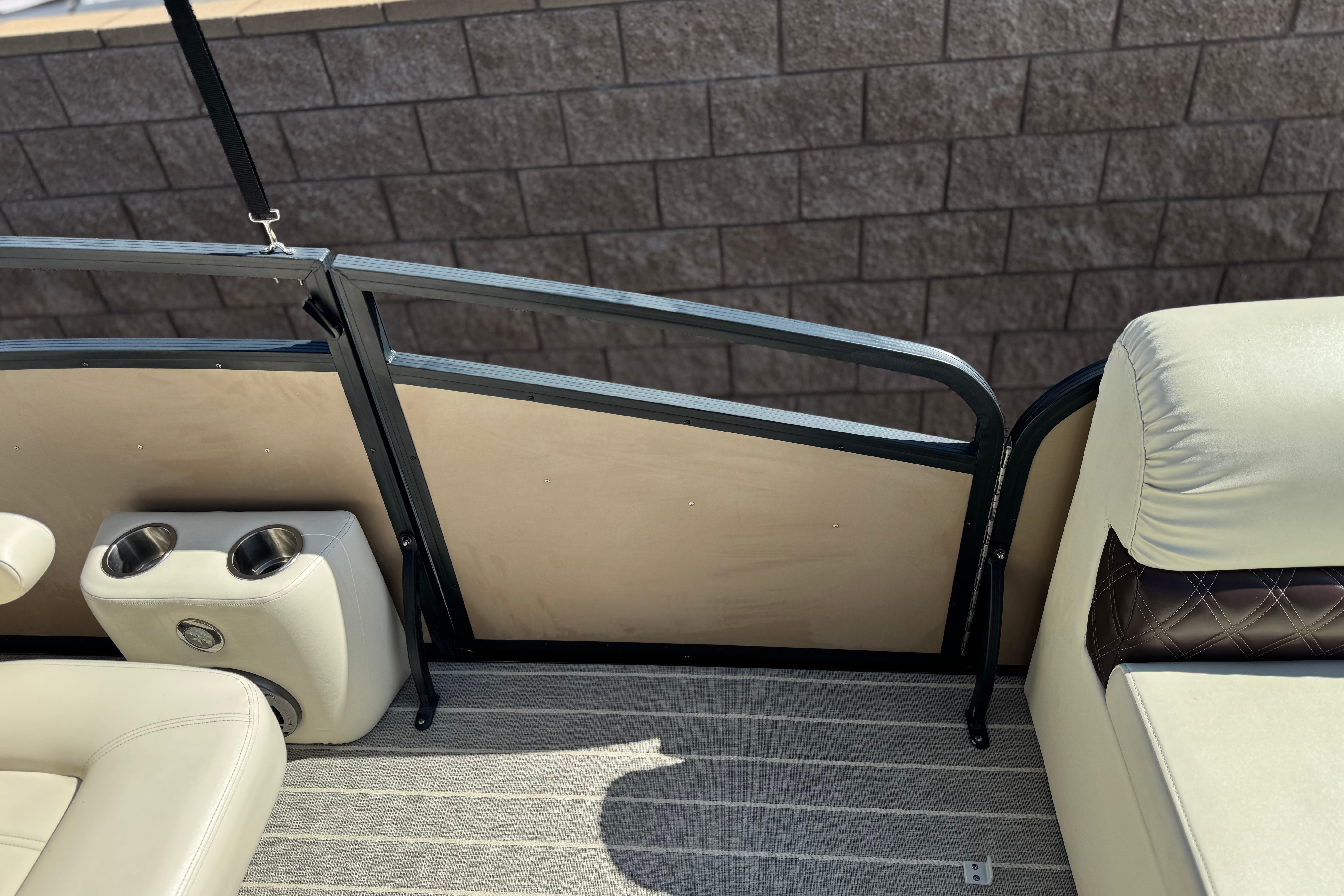 Interior of 2023 Lexington 623 ST Xtreme boat with beige seating and cup holders.