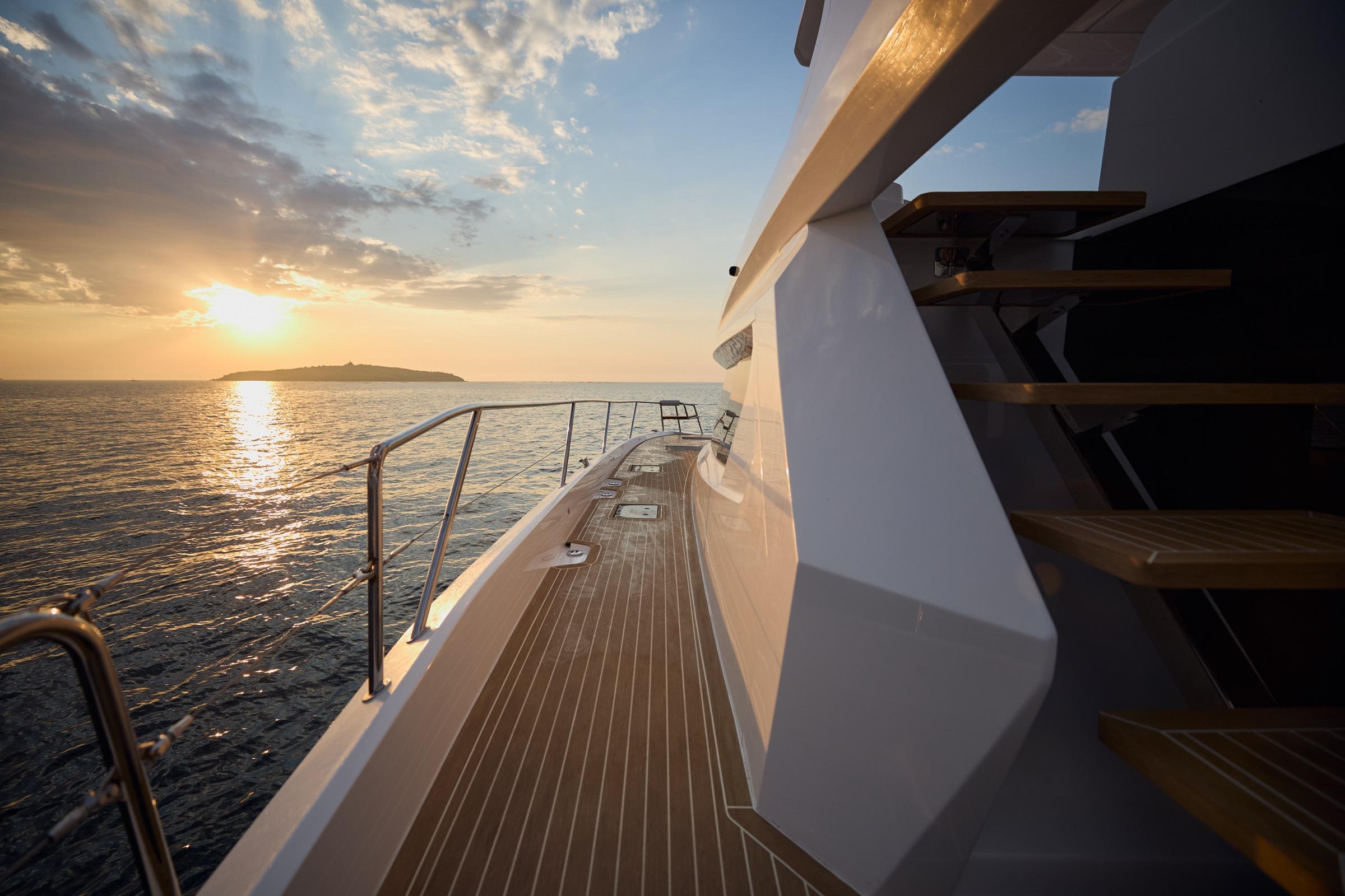 2025 Custom Omaya 50 Power Catamaran at sunset, ocean view, sleek design.