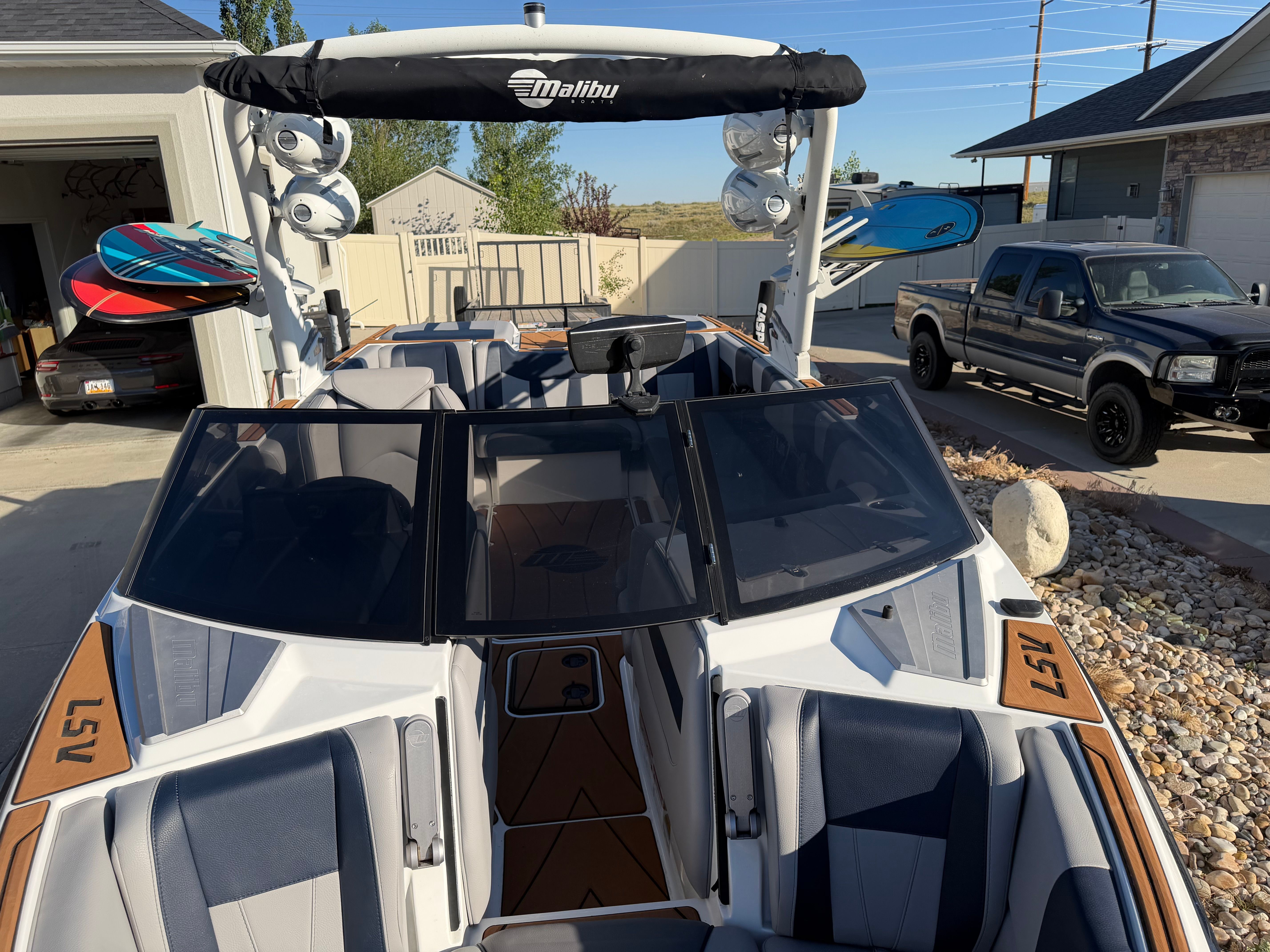 2021 Malibu Wakesetter 23 LSV with stylish design, blue seating, and wakeboard racks.