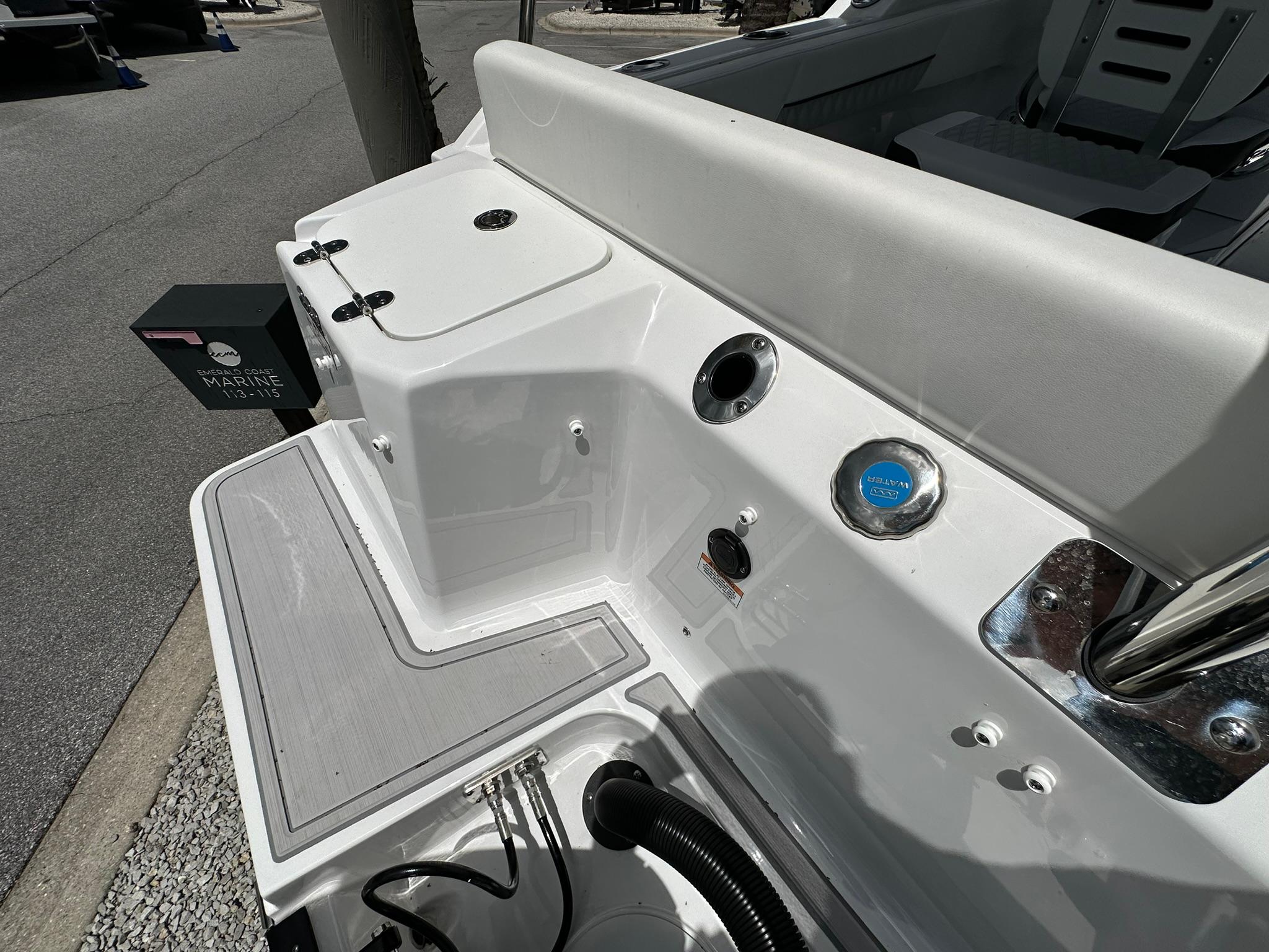 2024 Blackfin 232 DC boat deck with seating and storage compartments.