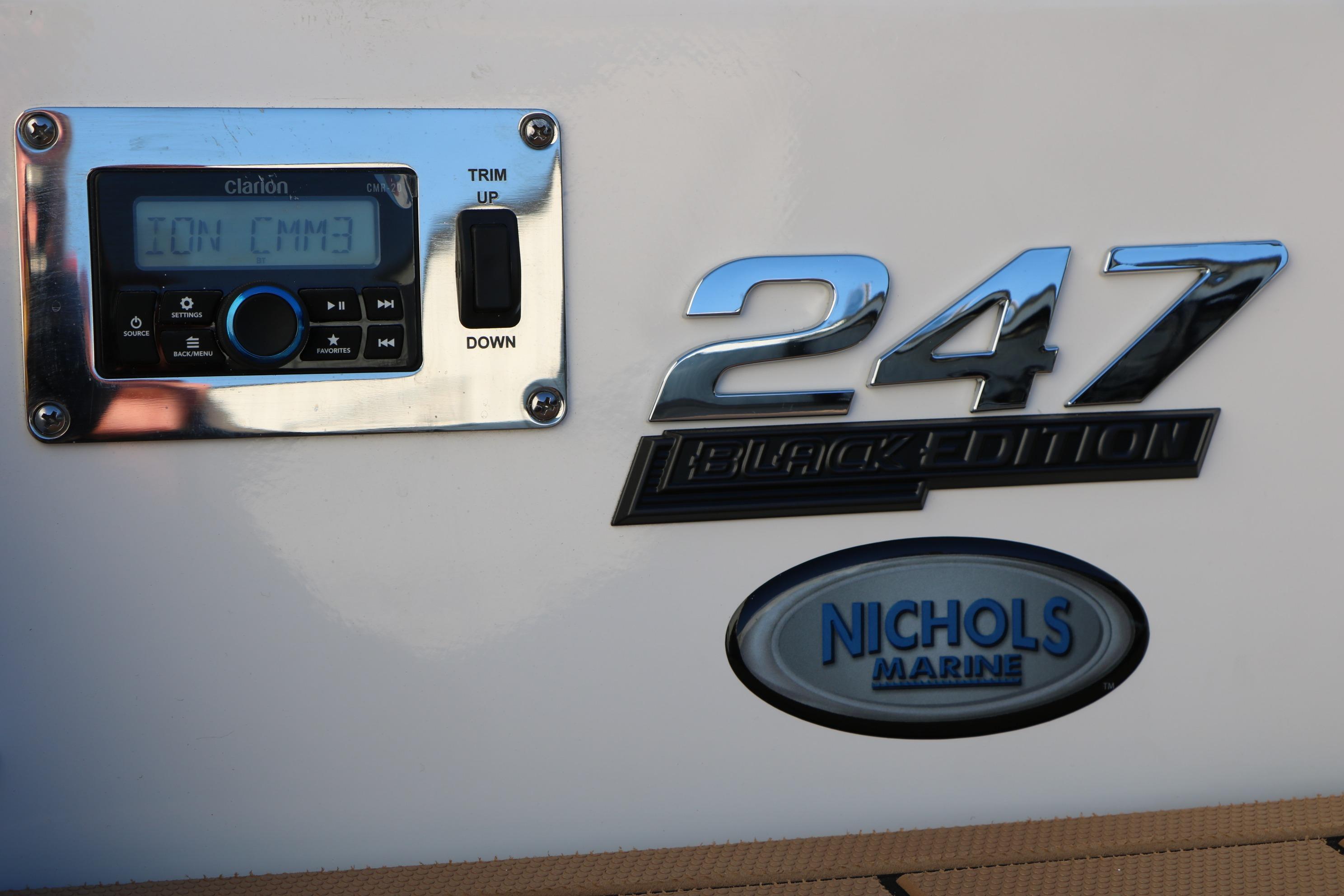 2026 Chaparral 247 SSX Black Edition boat with Clarion audio system and Nichols Marine logo.